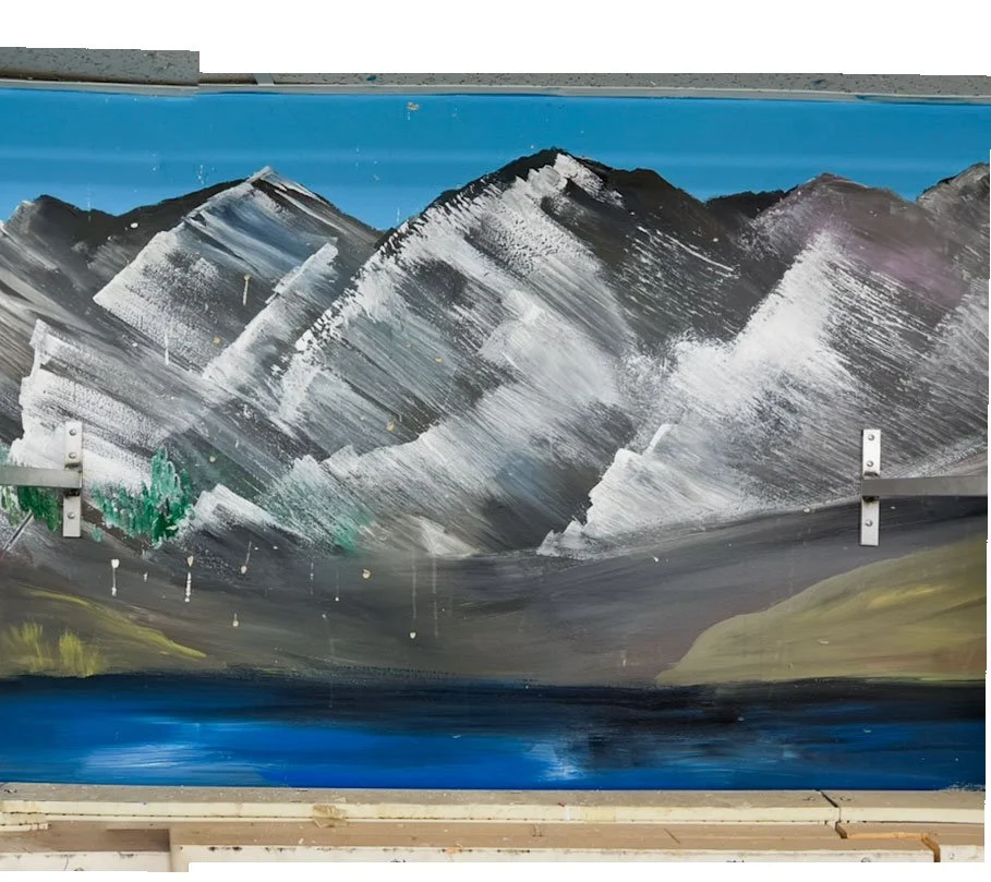 painted mountains with lake in front