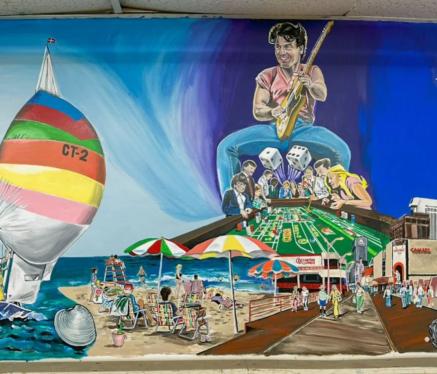 sail boat, beach, boardwalk, with craps table and guitar player in background