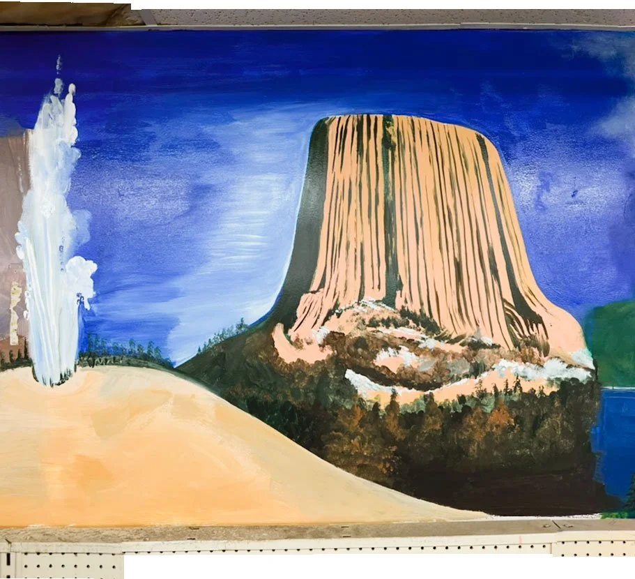 geyser erupting on left side, Devil's Tower on right side