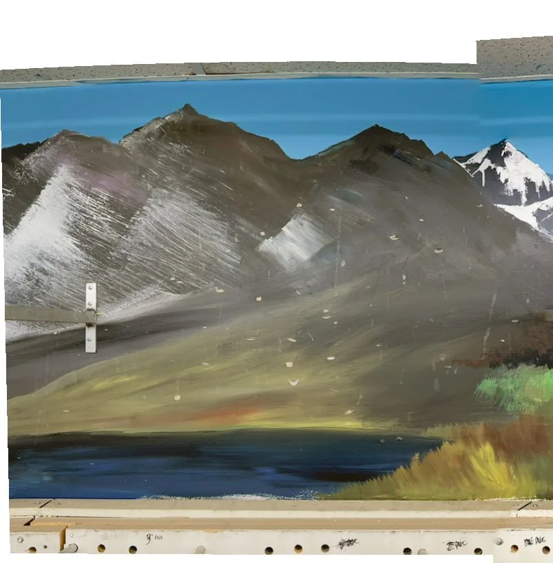 brown mountains with small lake in front