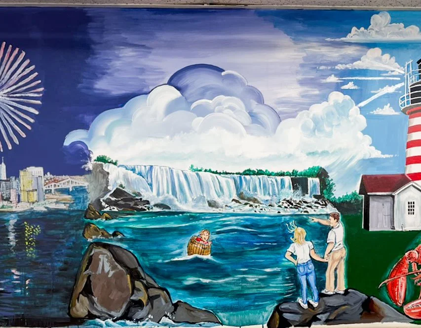 Niagara Falls with person in barrel in water and people in foreground