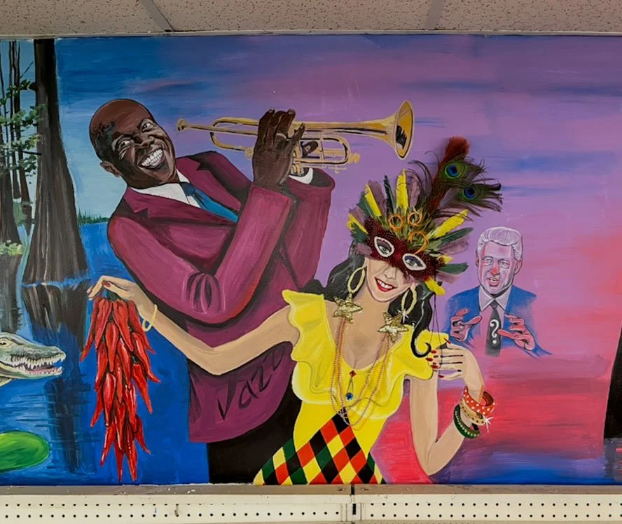 jazz musician Louis Armstrong left side above woman in Mardi Gras costume holding chilis center, President Clinton to her right