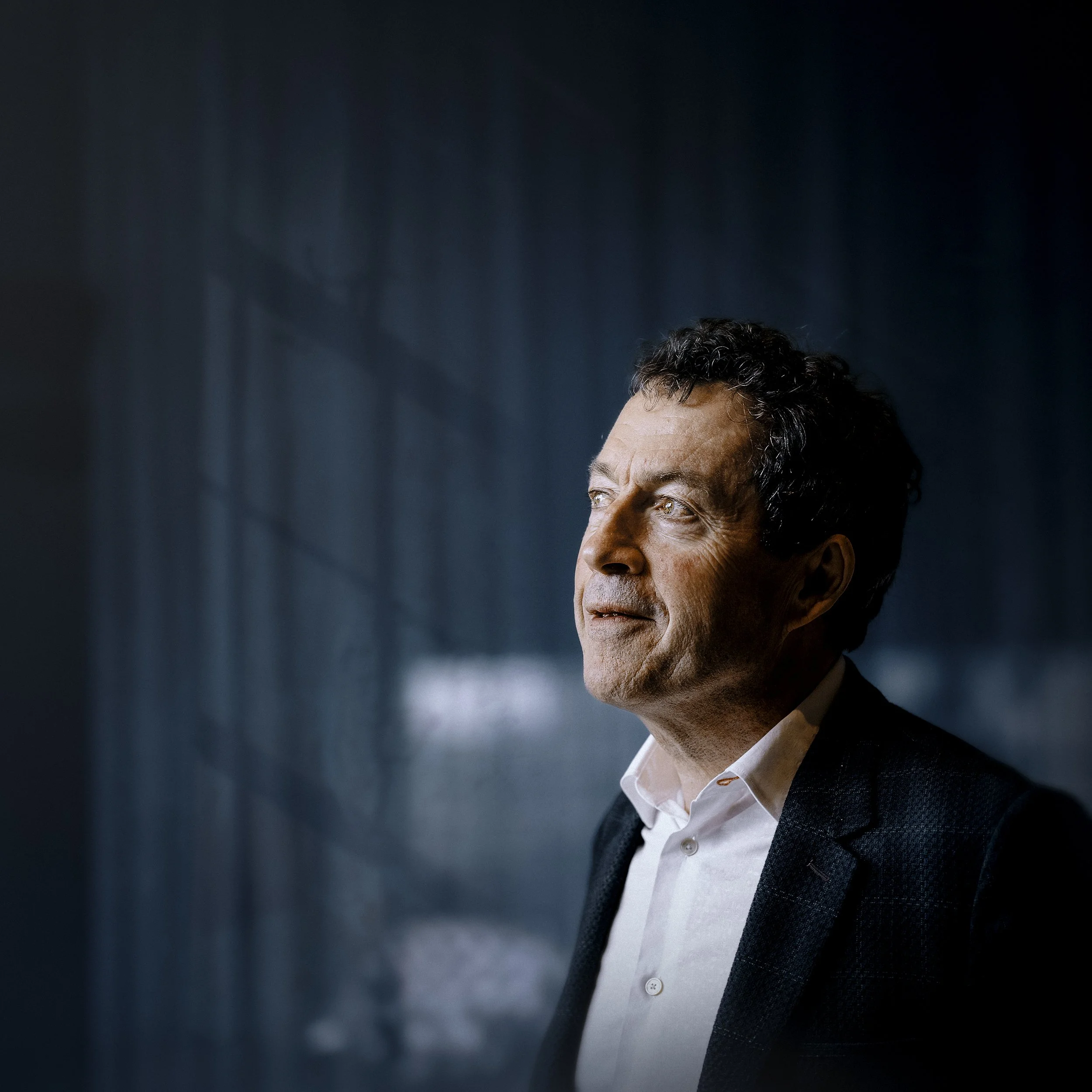 Penfolds chief winemaker, Peter Gago, side-on, looking up towards the light.