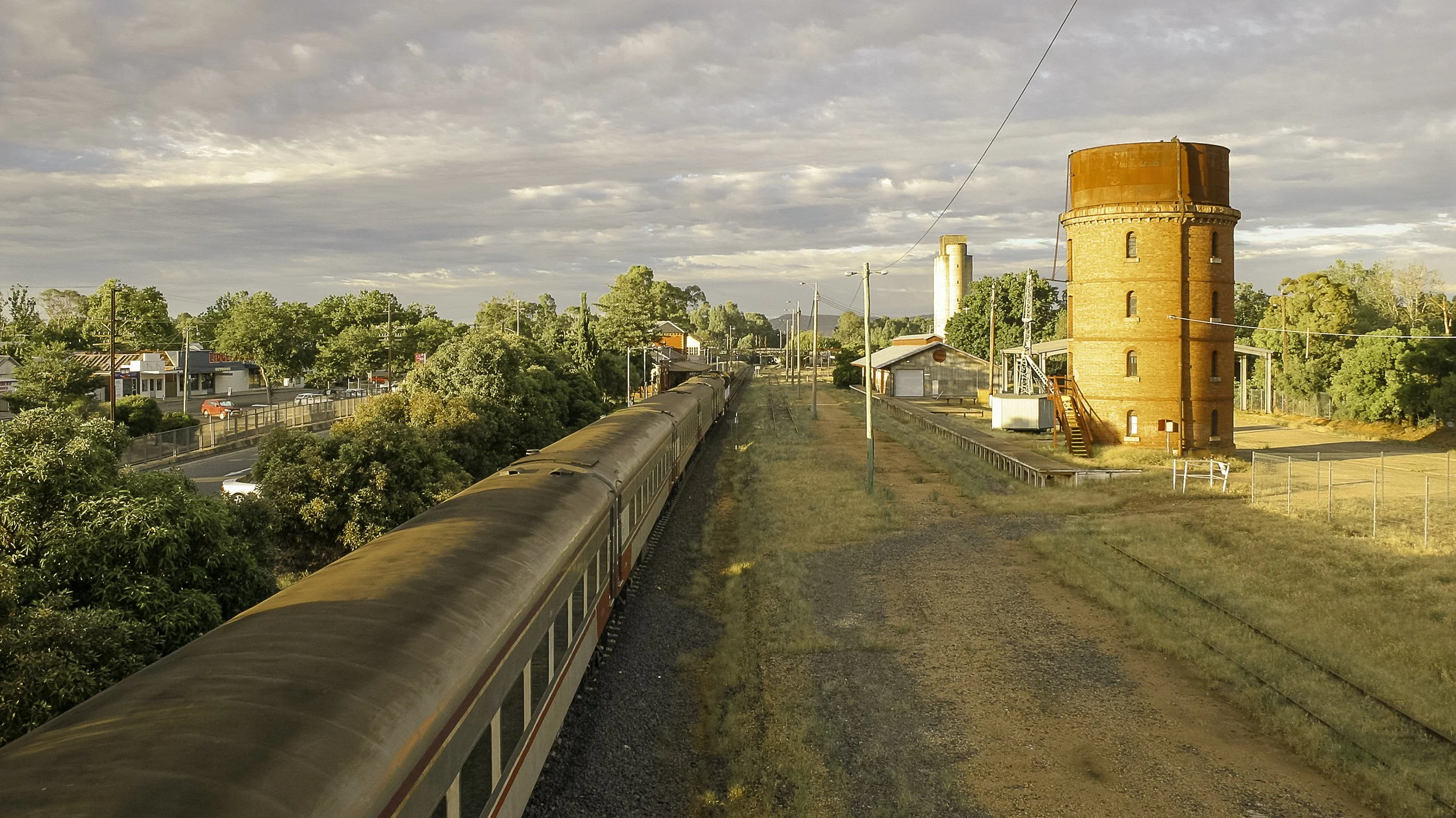 Sydney-to-Melbourne train pulls into the Wangaratta Railway Station on a warm, golden summer's morning.