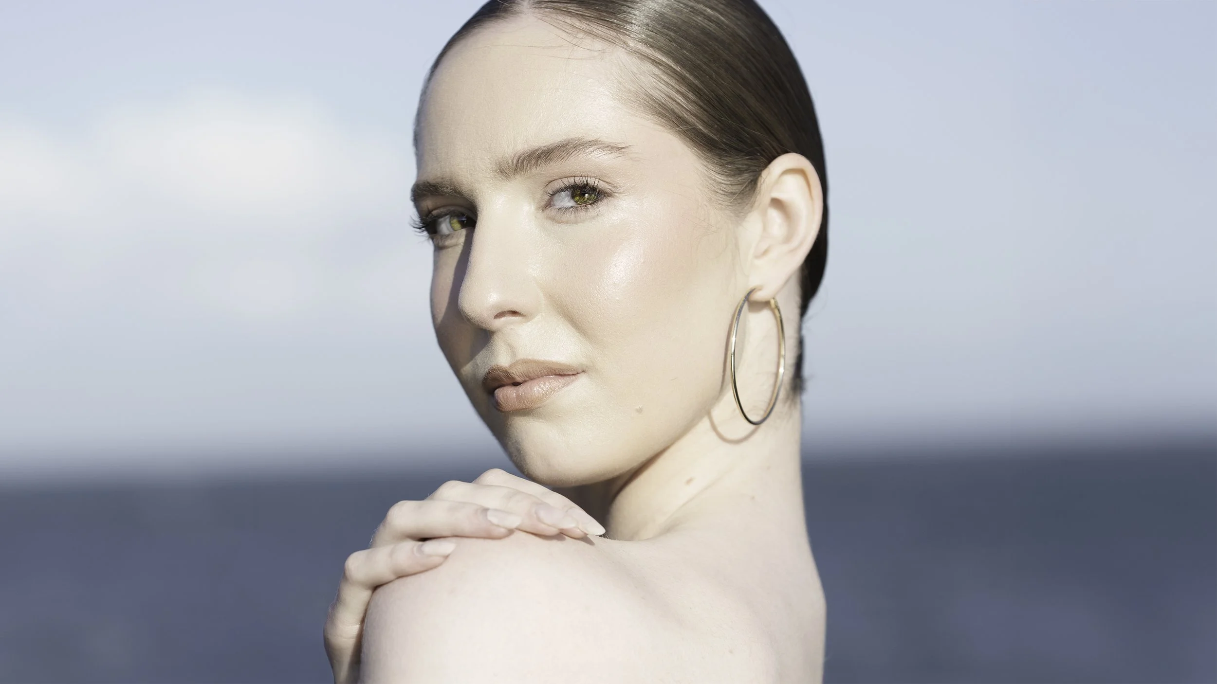 Australian model Nicola Paige stands on a jetty at Altona Beach, bright sun, fashion editorial vibe.