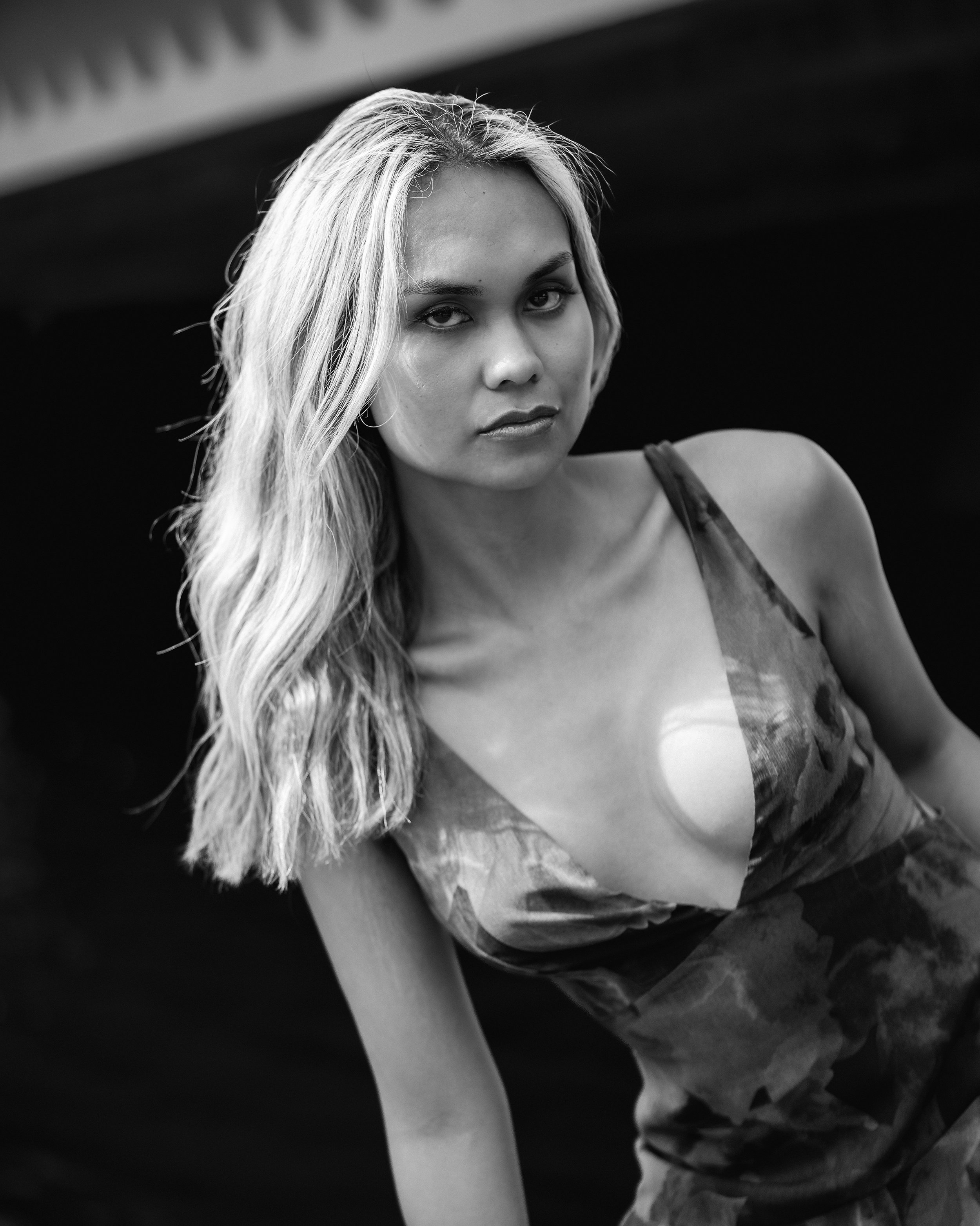 Shevonne Ambanloc, wearing a summer dress, looks straight at the camera.