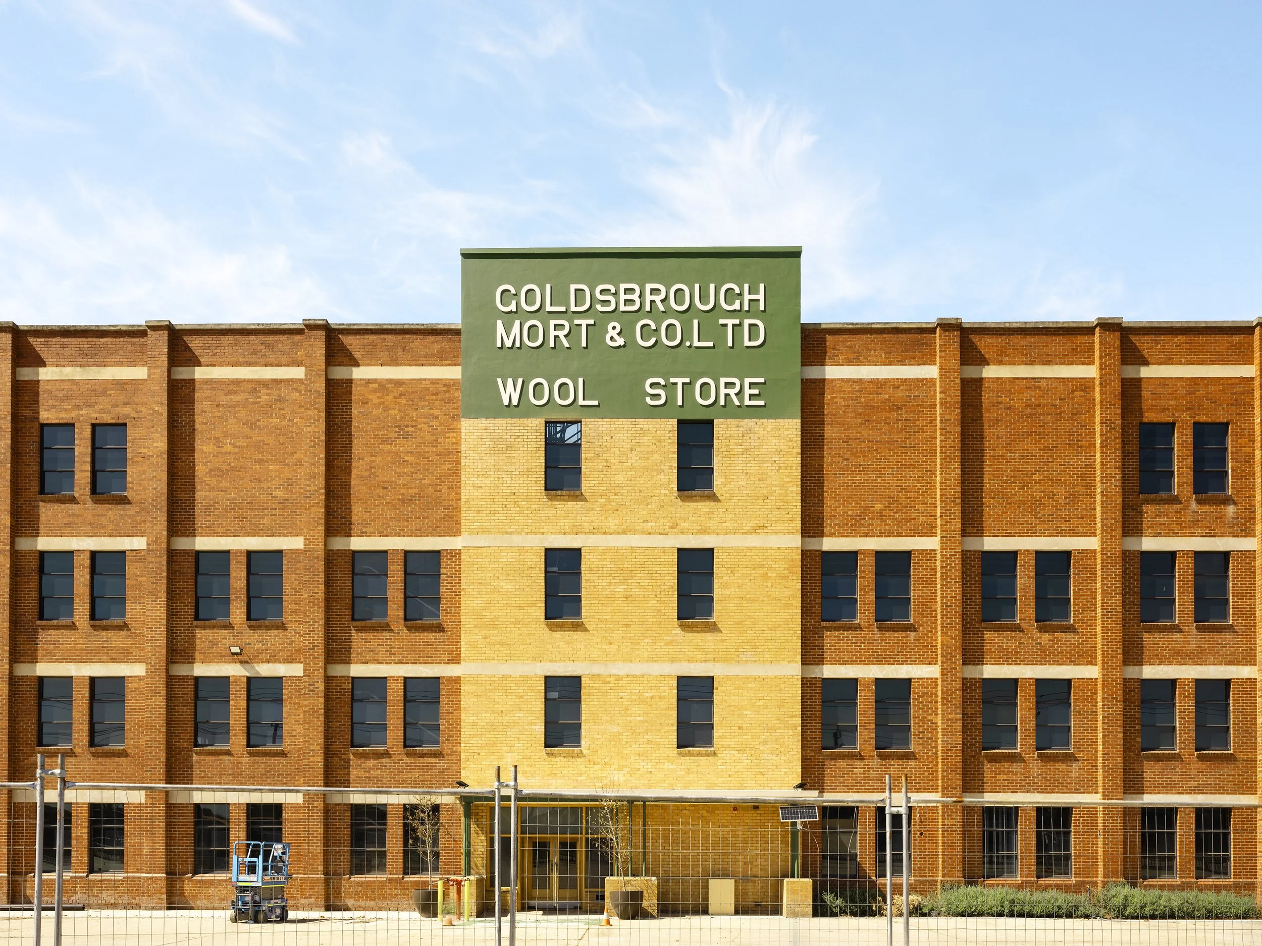 The Goldsbrough Mort & Co building on the corner of McArthur Street and Sunshine Road (1 McArthur Street/63 Sunshine Rd) in West Footscray, full sun, fence in front, post renovation.
