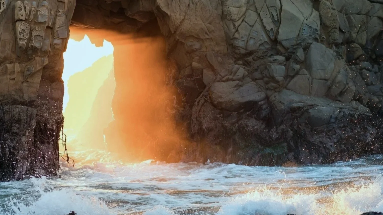 Light breaking through coastal rock formation —  breakthrough moments in diversity coaching and inclusive leadership development