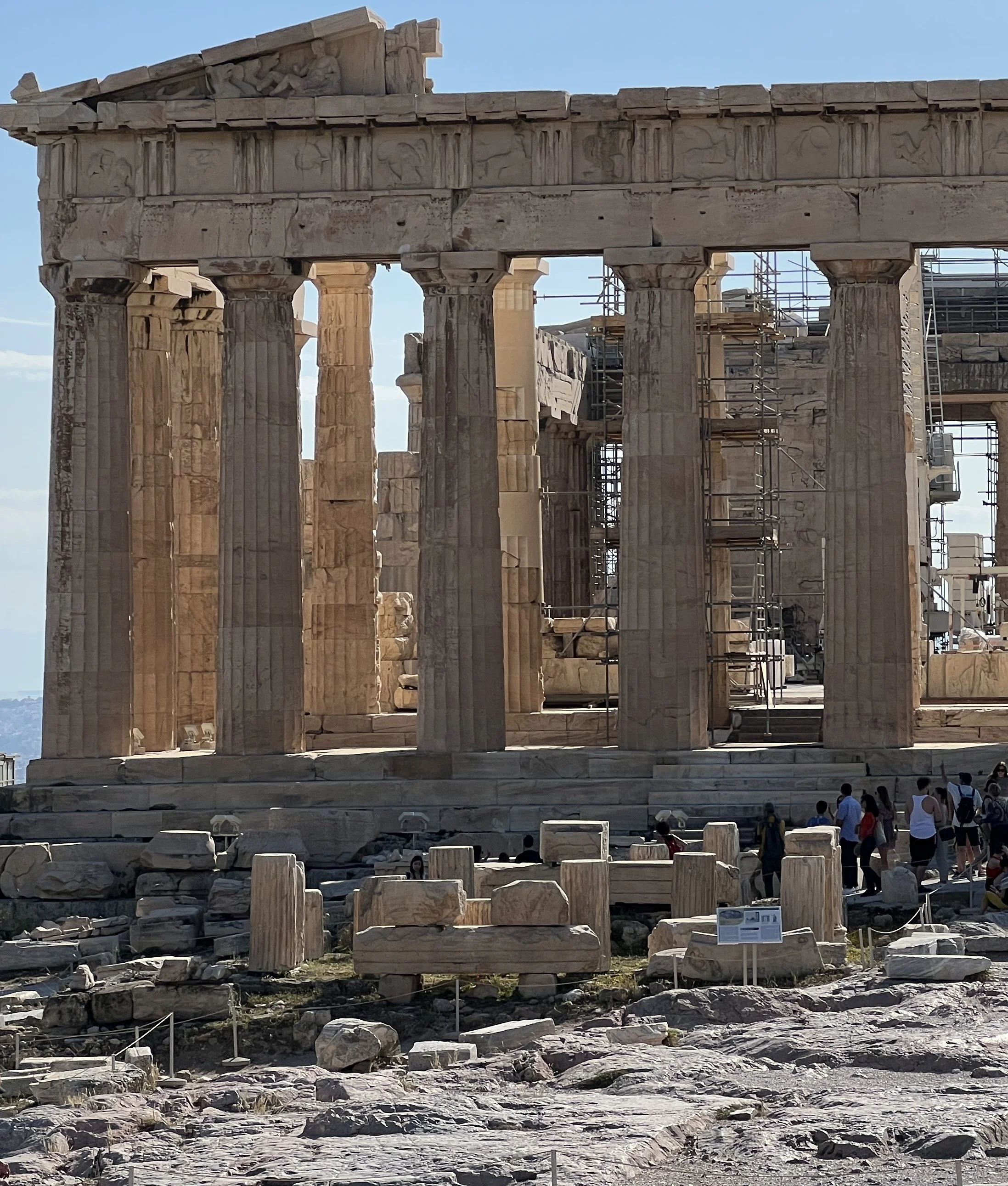 In the foreground - low round platform with partial columns around it - Temple of Augustus on the Athens Acropolis at the east end of the Parthenon.
