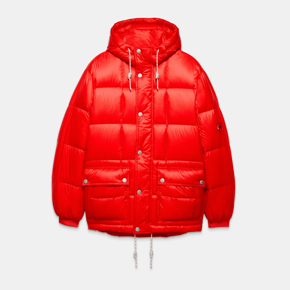 Bright red insulated Direttissima jacket—front view with snap pockets and rope hem.