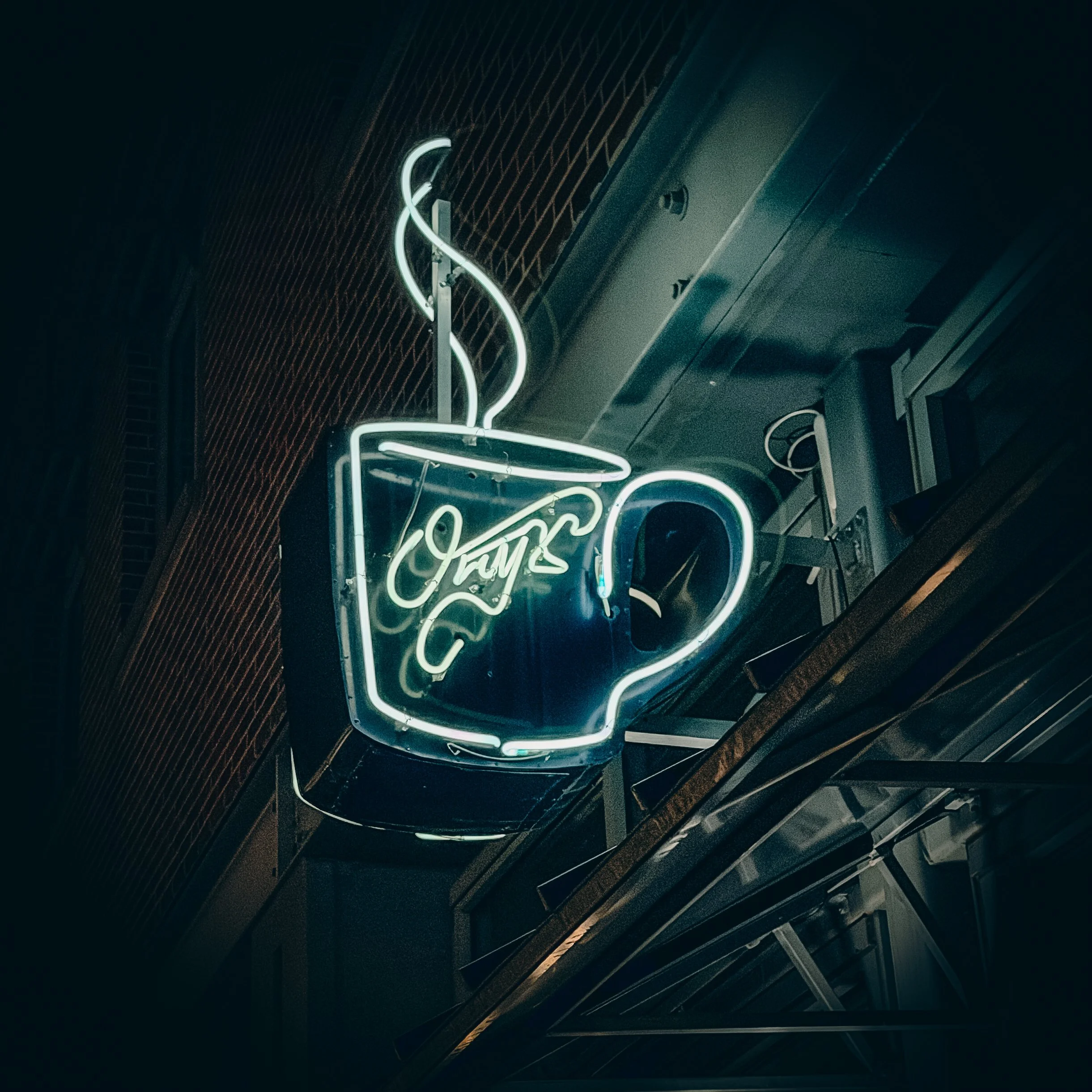Neon coffee cup sign at Onyx Coffee Lab