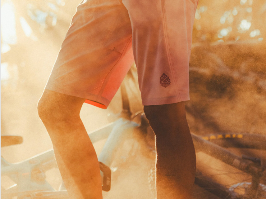 Close-up of pink Stio Women’s OPR mountain bike shorts in dusty sunlight