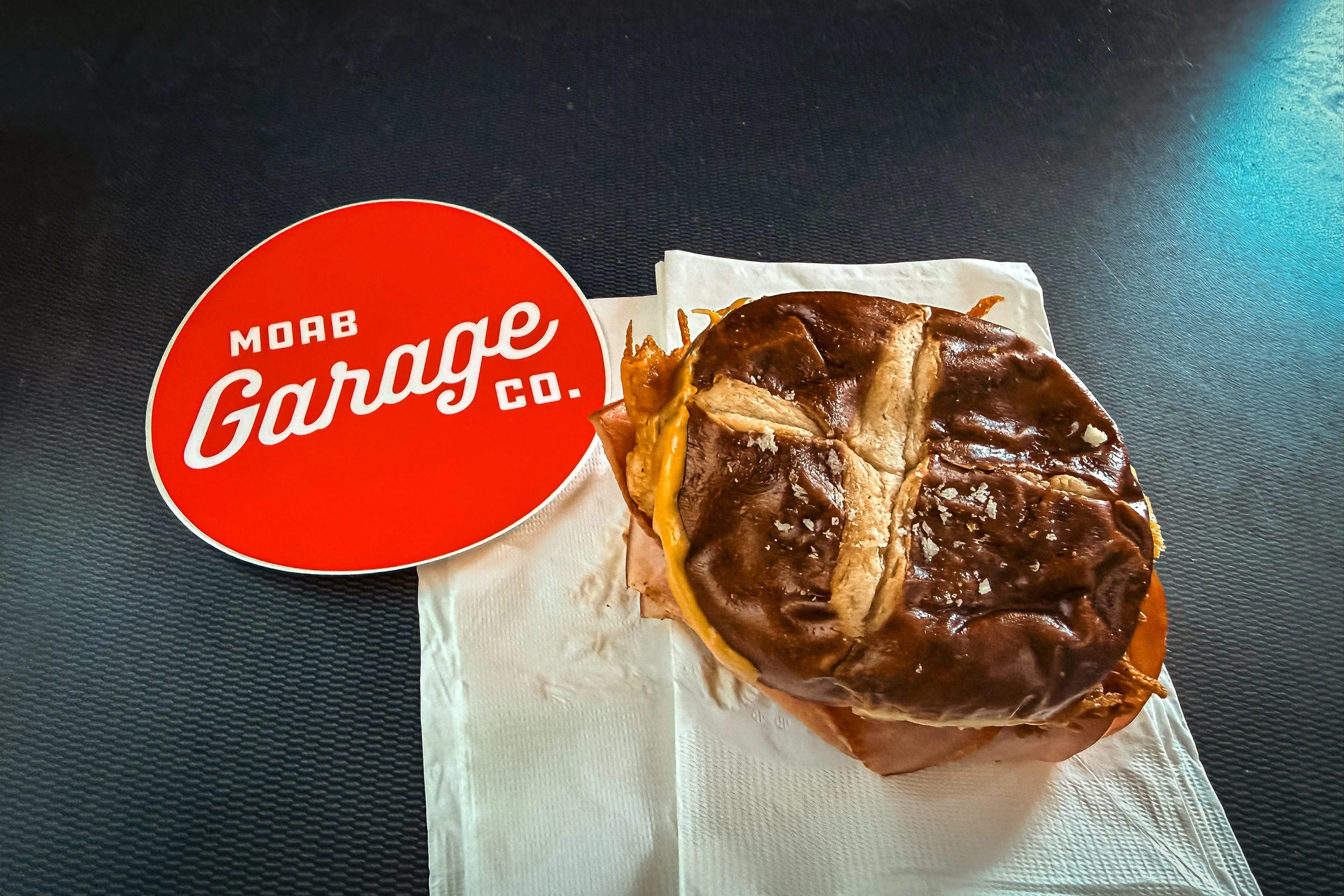 McLovin breakfast sandwich with bacon egg and cheese on a pretzel bun from Moab Garage Co in Moab Utah