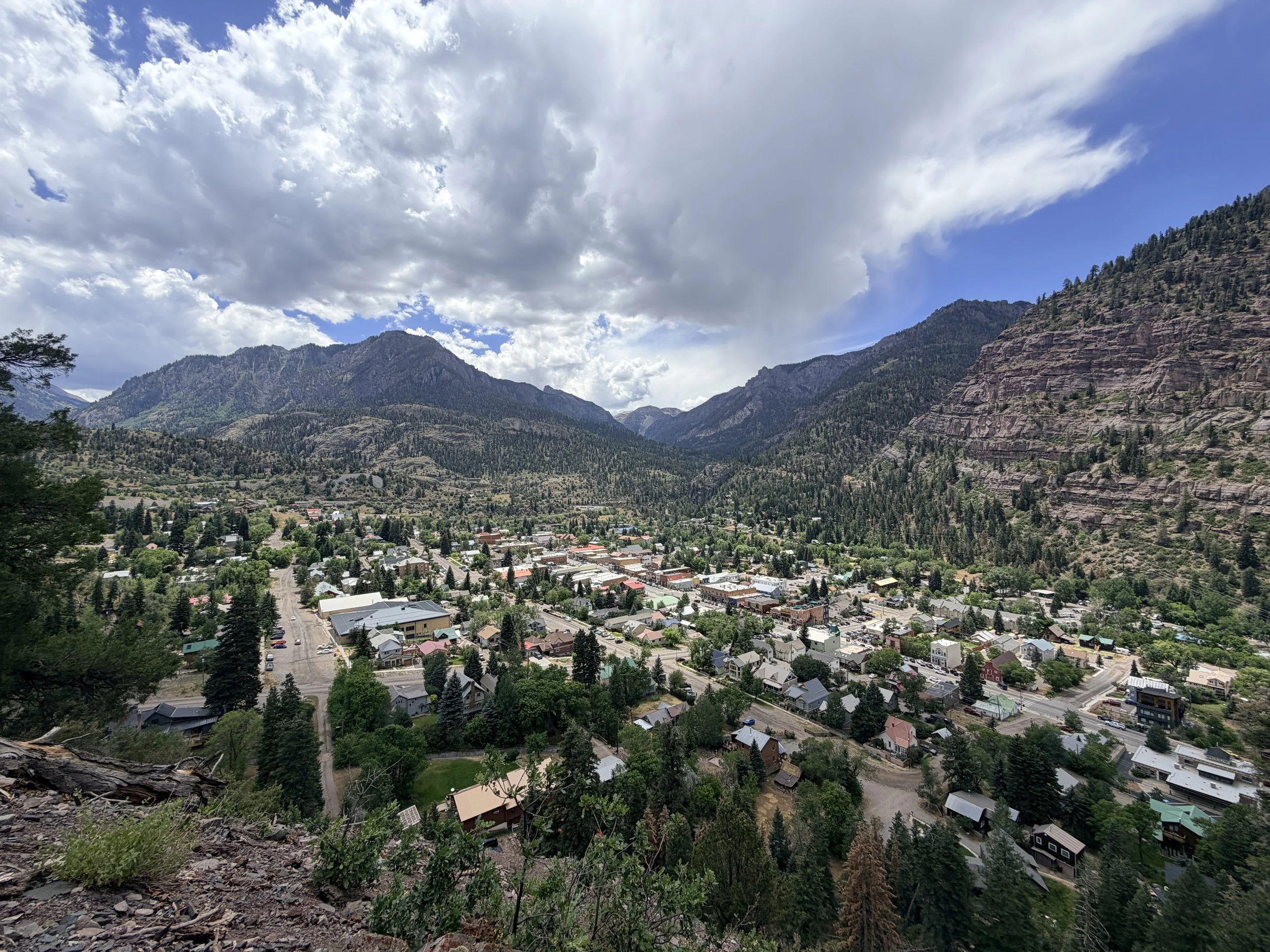 Elevated view of Ouray, Colorado nestled in a valley surrounded by the San Juan Mountains, seen from the Perimeter Trail.