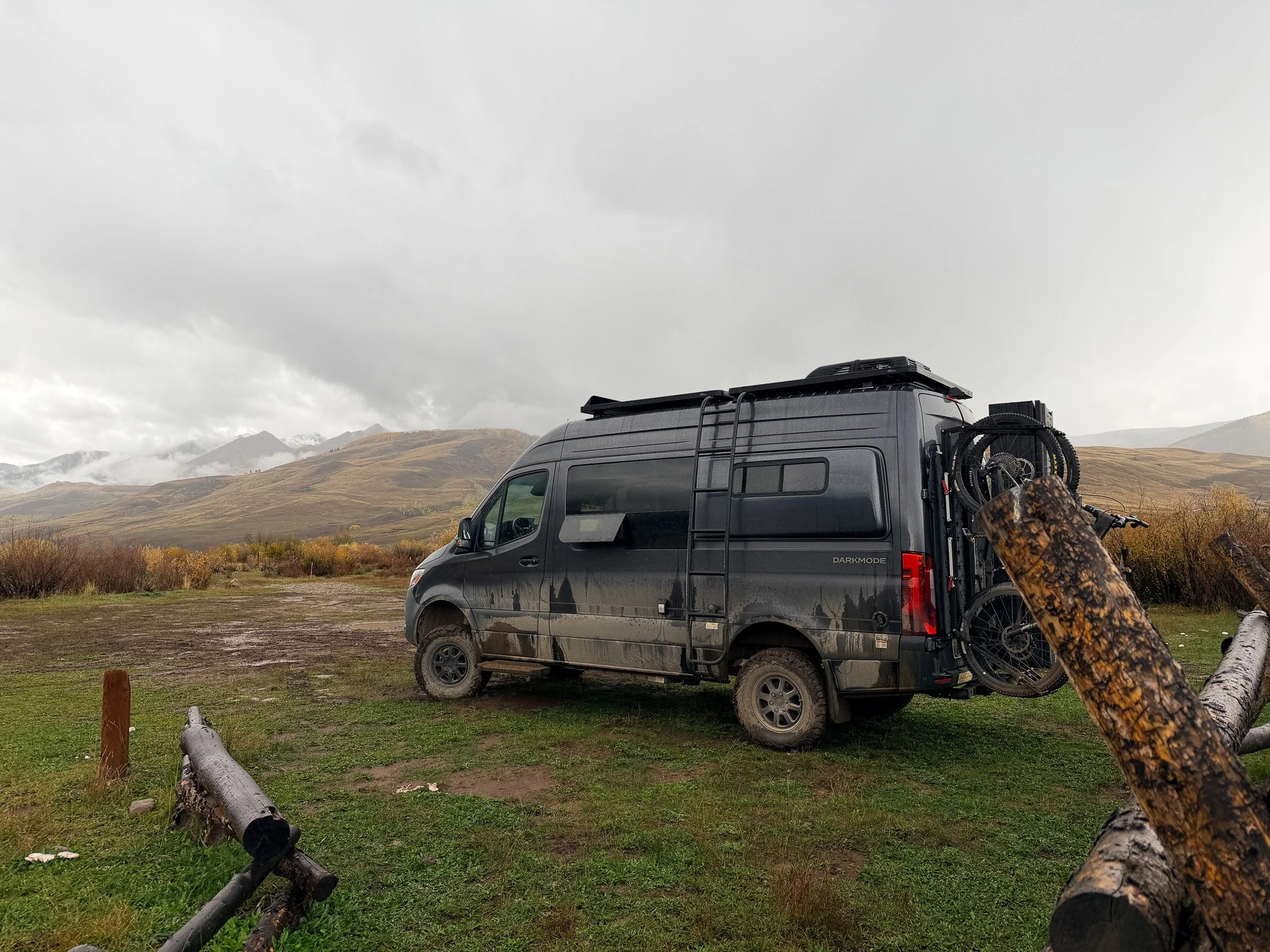 Black Storyteller Overland Sprinter camper van with mountain bikes on the back at a dispersed BLM campsite near Strand Hill in Crested Butte, Colorado.