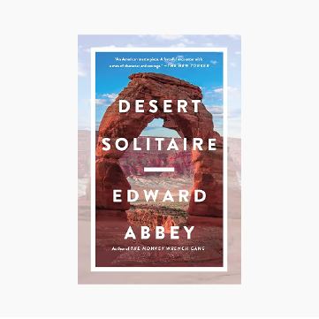 Book cover titled 'Desert Solitaire' by Edward Abbey, featuring an image of a natural rock arch formation in a desert landscape with a blue sky.