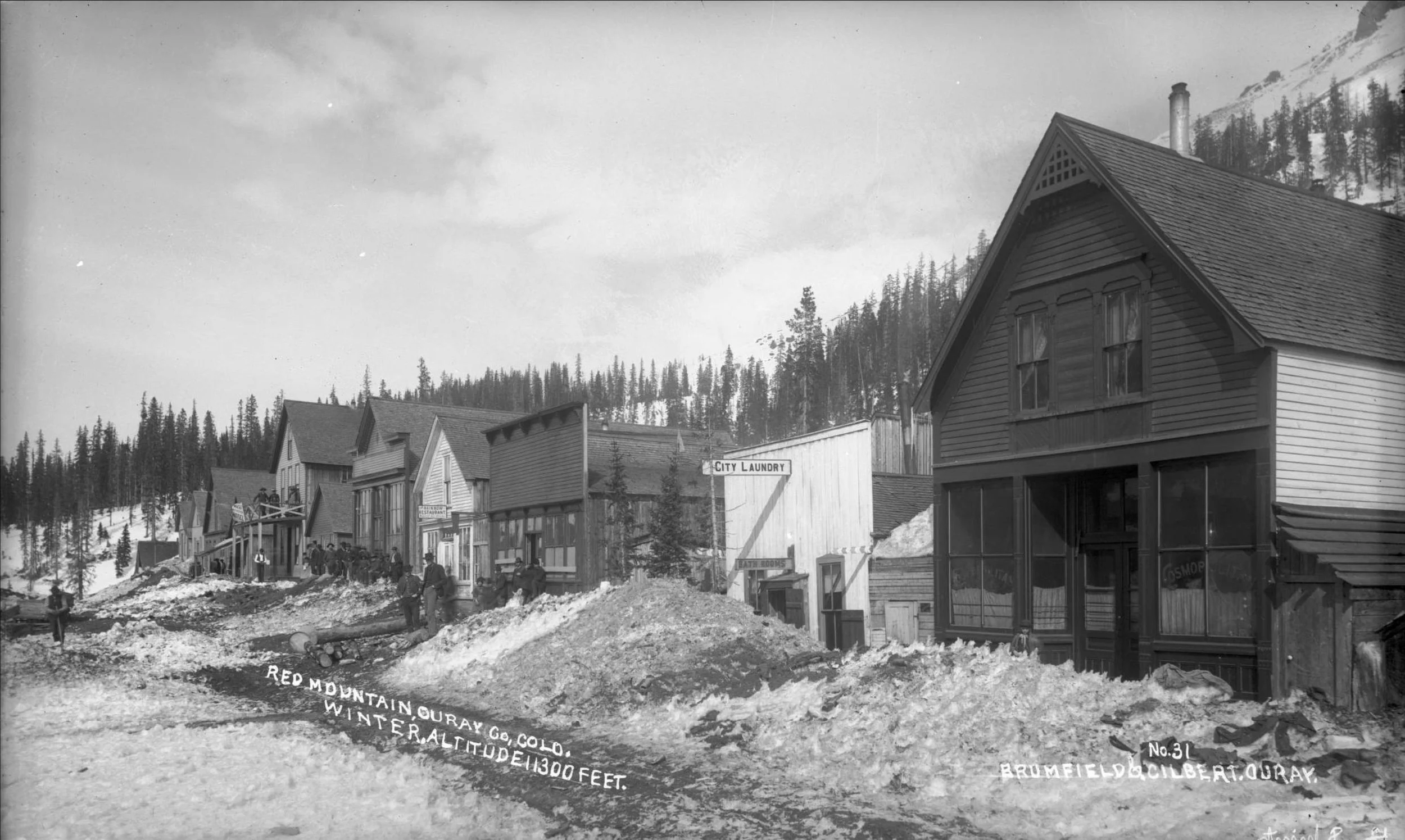 Historic photograph of Red Mountain, Colorado, with businesses and snow-covered streets during the mining era.