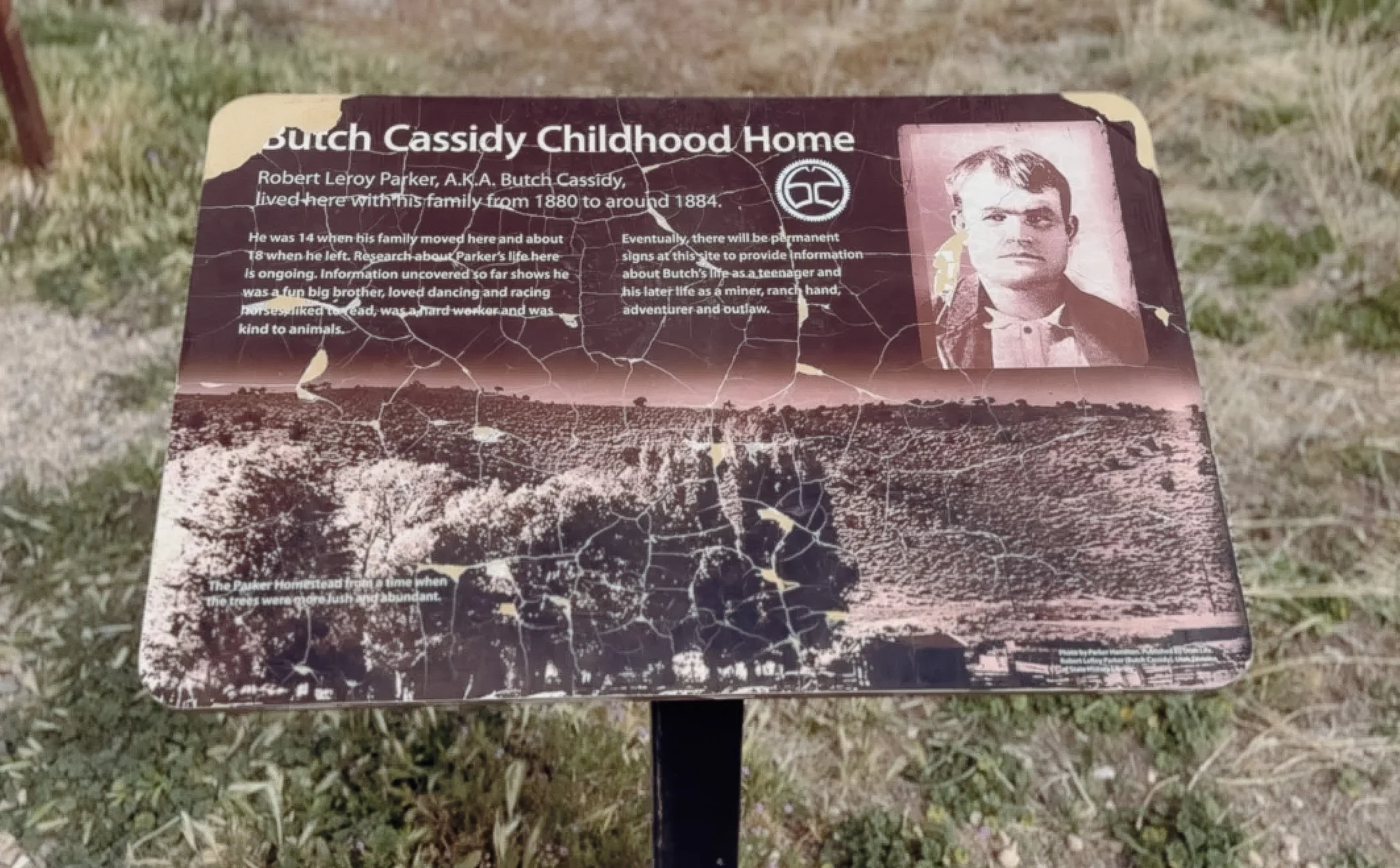 Interpretive sign at Butch Cassidy's childhood home describing Robert LeRoy Parker's life near Circleville, Utah.