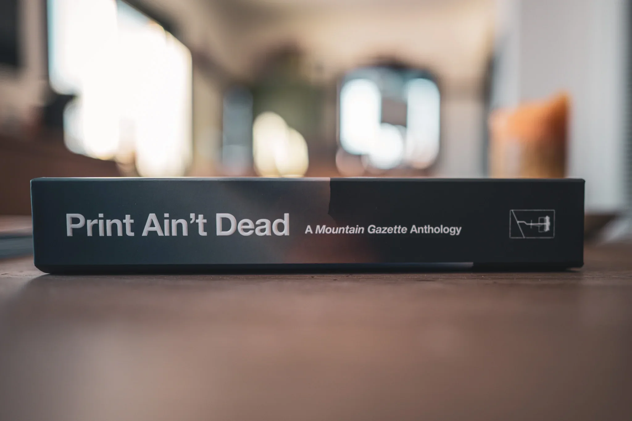 Side view of the Print Ain't Dead Mountain Gazette anthology showing the book spine.