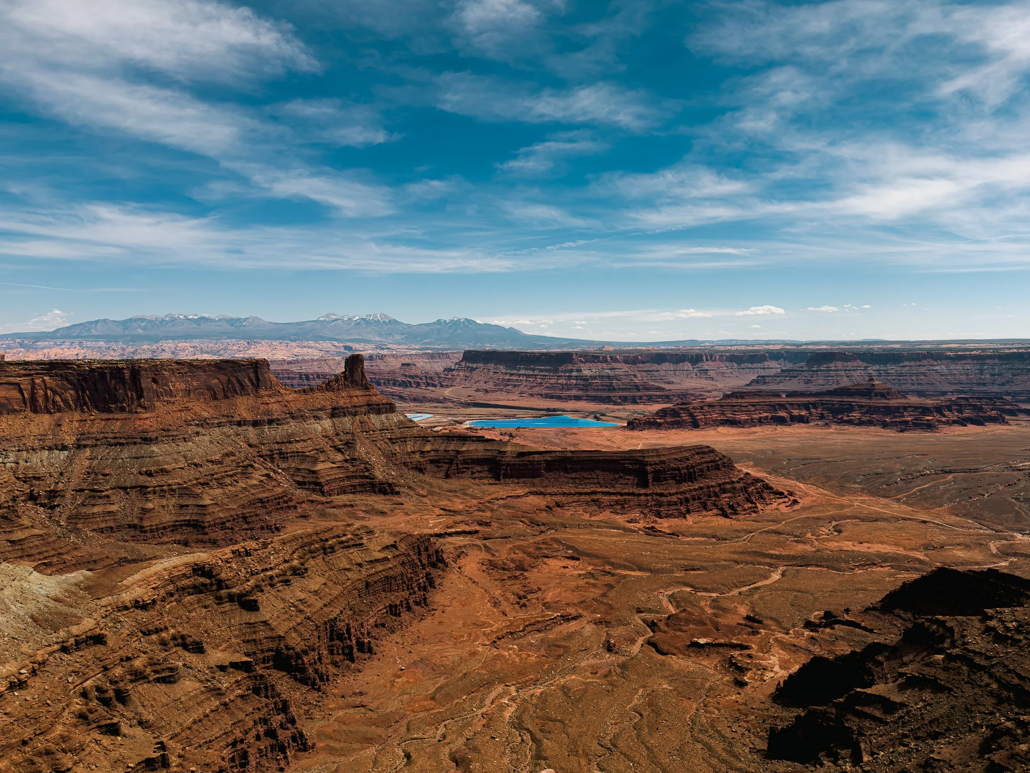 View from Dead Horse Point State Park overlooking canyon layers and blue potash evaporation ponds near Moab, Utah