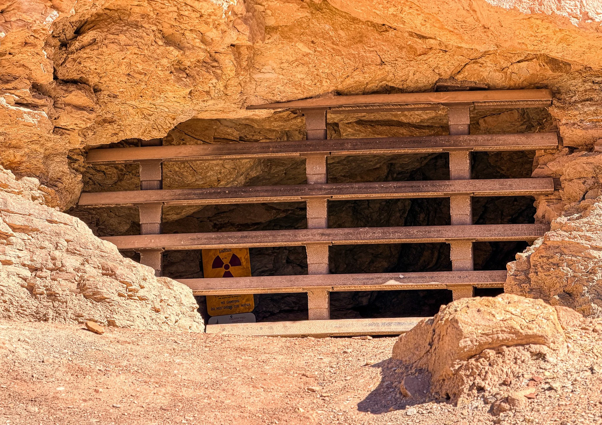 Boarded uranium mine opening with radiation warning sign near Grand Wash Road in Capitol Reef National Park Utah
