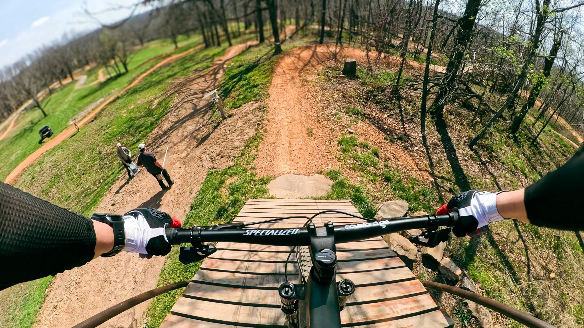 Rider’s point of view dropping off a wooden feature into the Catapult trail from the Castle at Slaughter Pen in Bentonville, Arkansas.