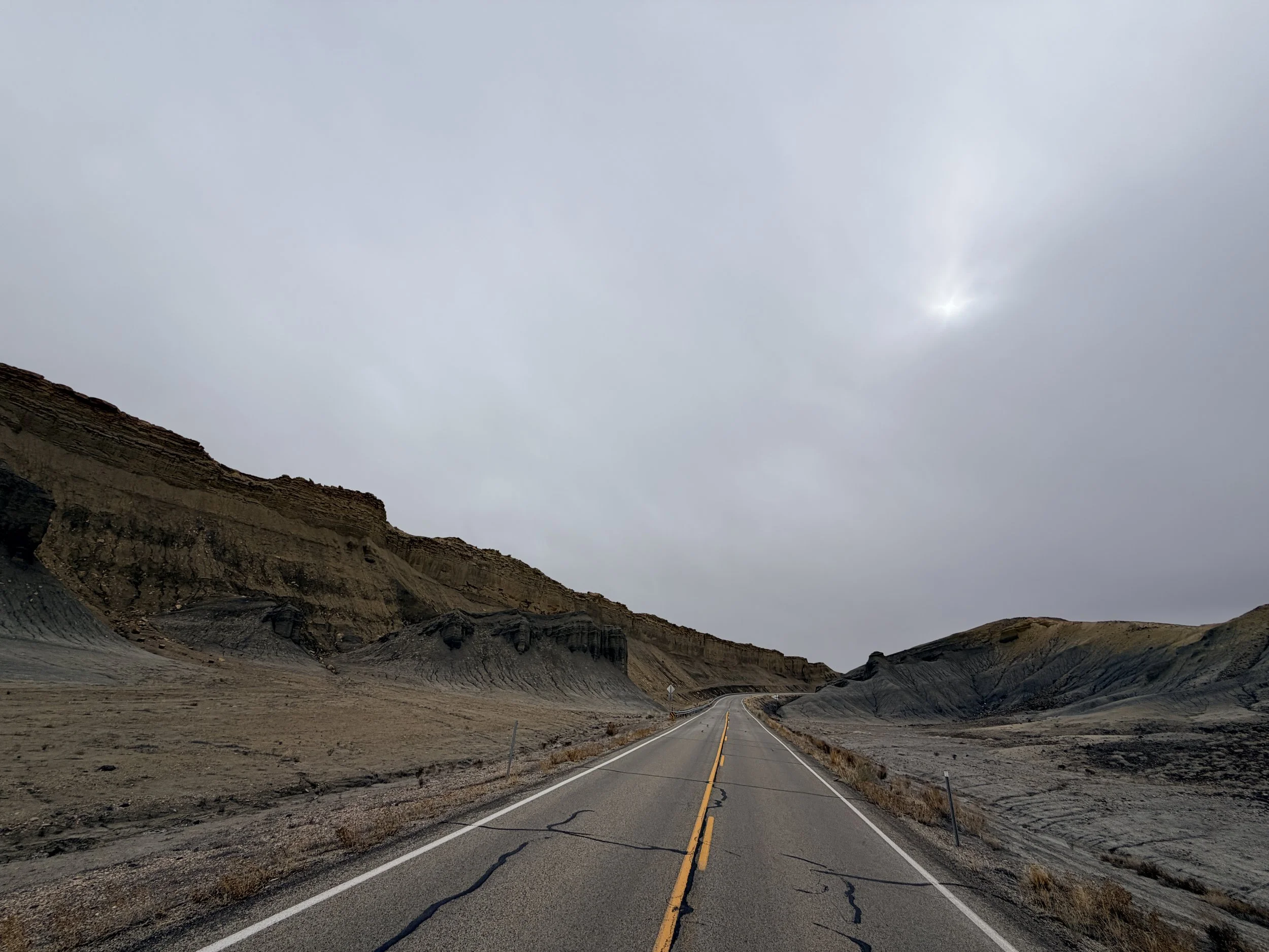 Layered desert rock formations along highway in southern Utah