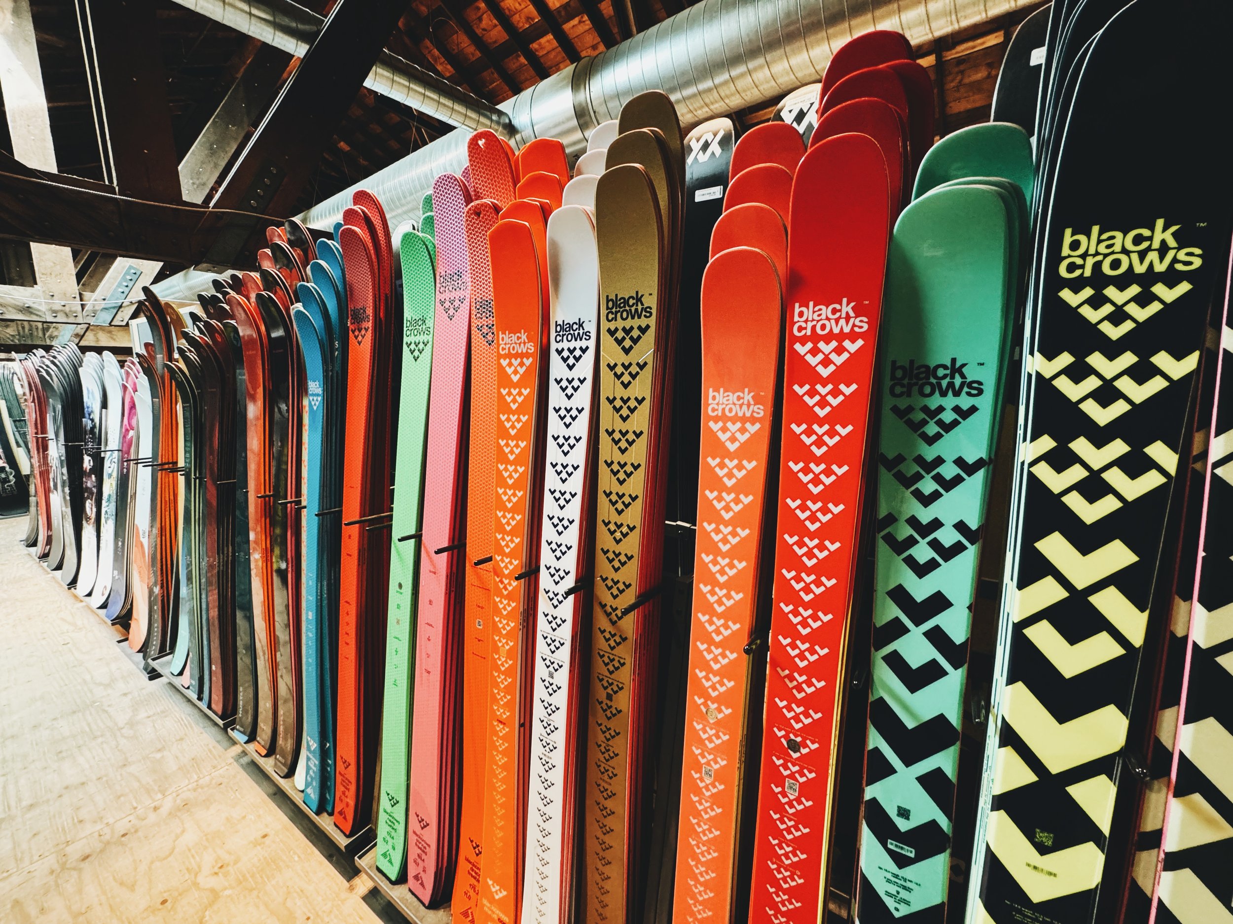EVO store display at Campus Salt Lake with multiple Black Crows skis on display, showcasing the brand’s variety of models and vibrant design.