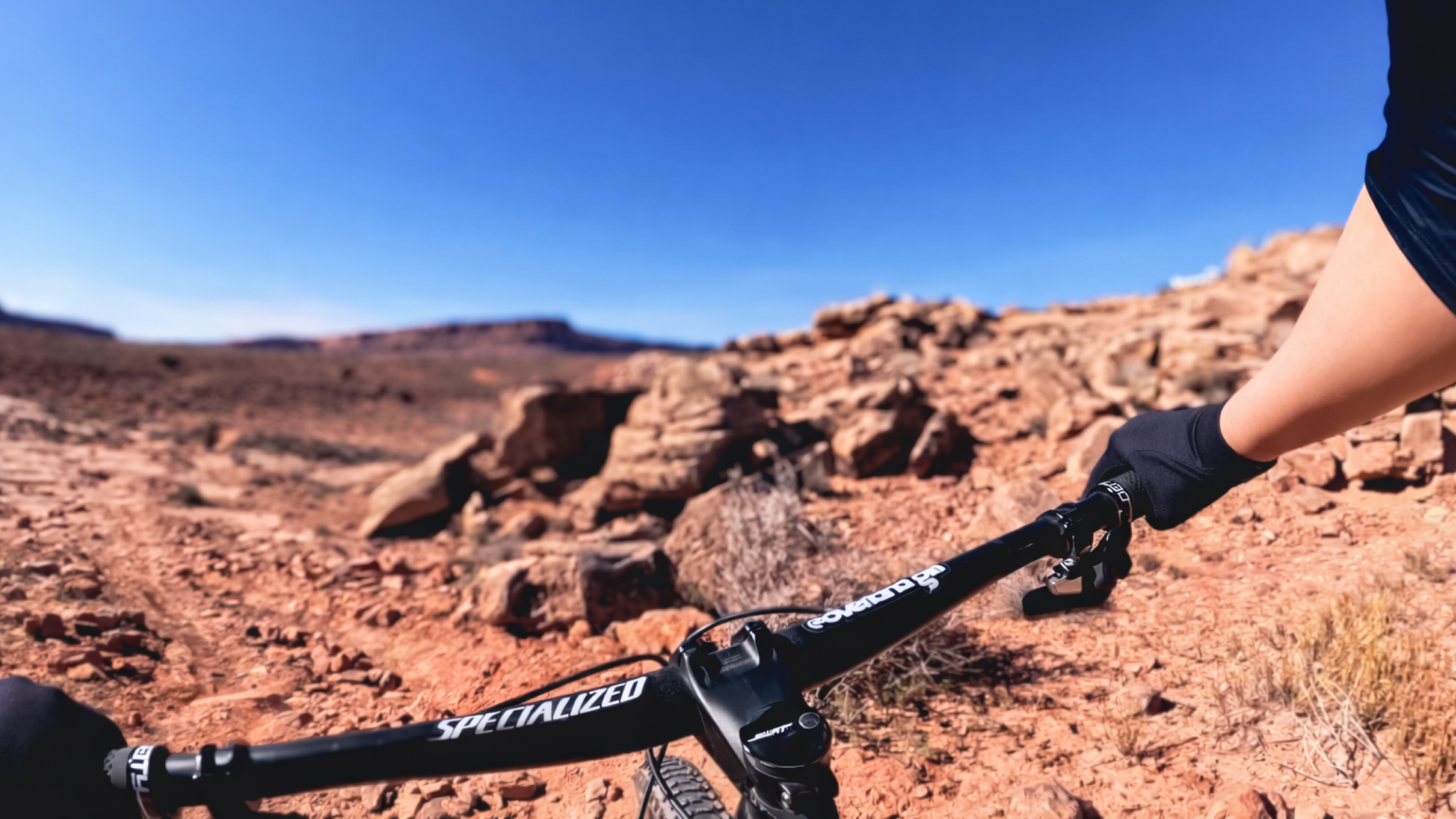 First-person view mountain biking North 40 Trail at the Moab Brand Trails in Moab, Utah, with a Specialized mountain bike on rocky red desert singletrack.