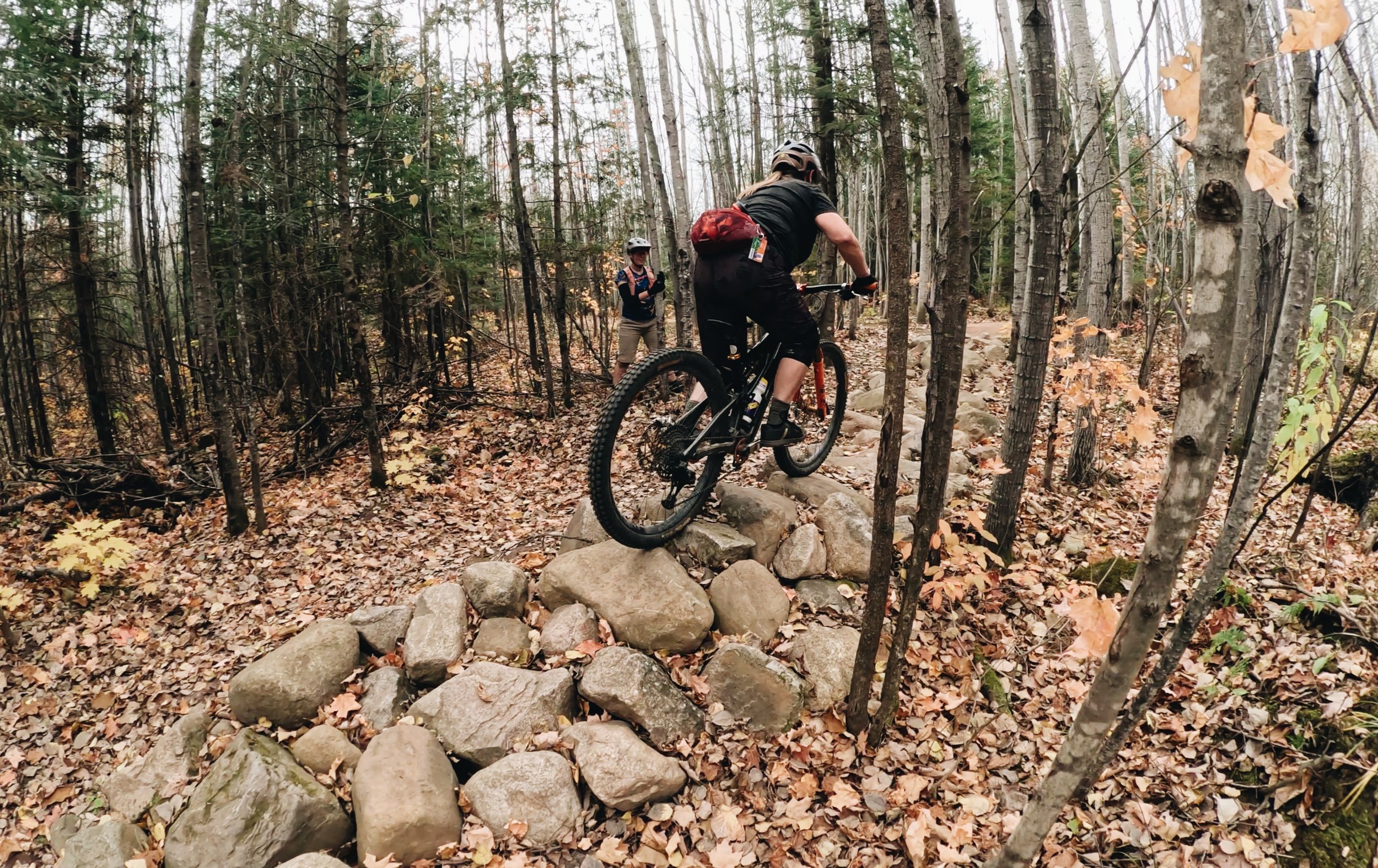 Mountain biker Coach Brenda riding a technical rock garden trail on an S-Works Stumpjumper in Wisconsin