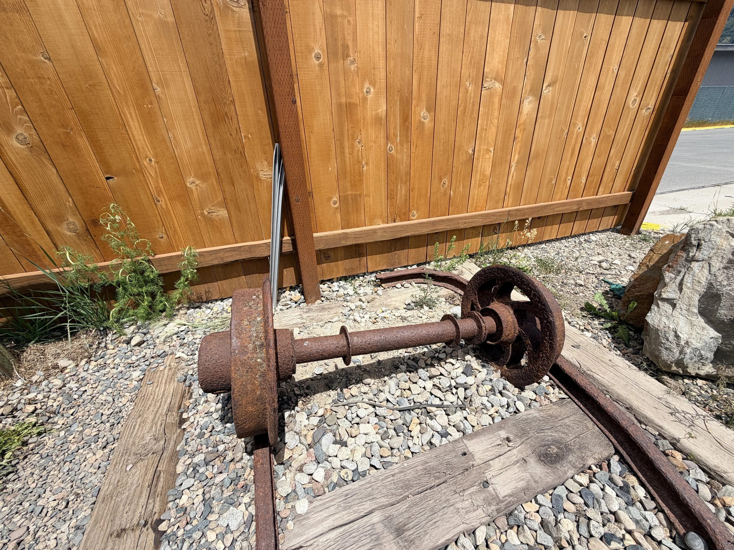 Historic mine cart axle and wheels displayed near the RV dump station in Crested Butte, Colorado, highlighting the town's coal mining history.
