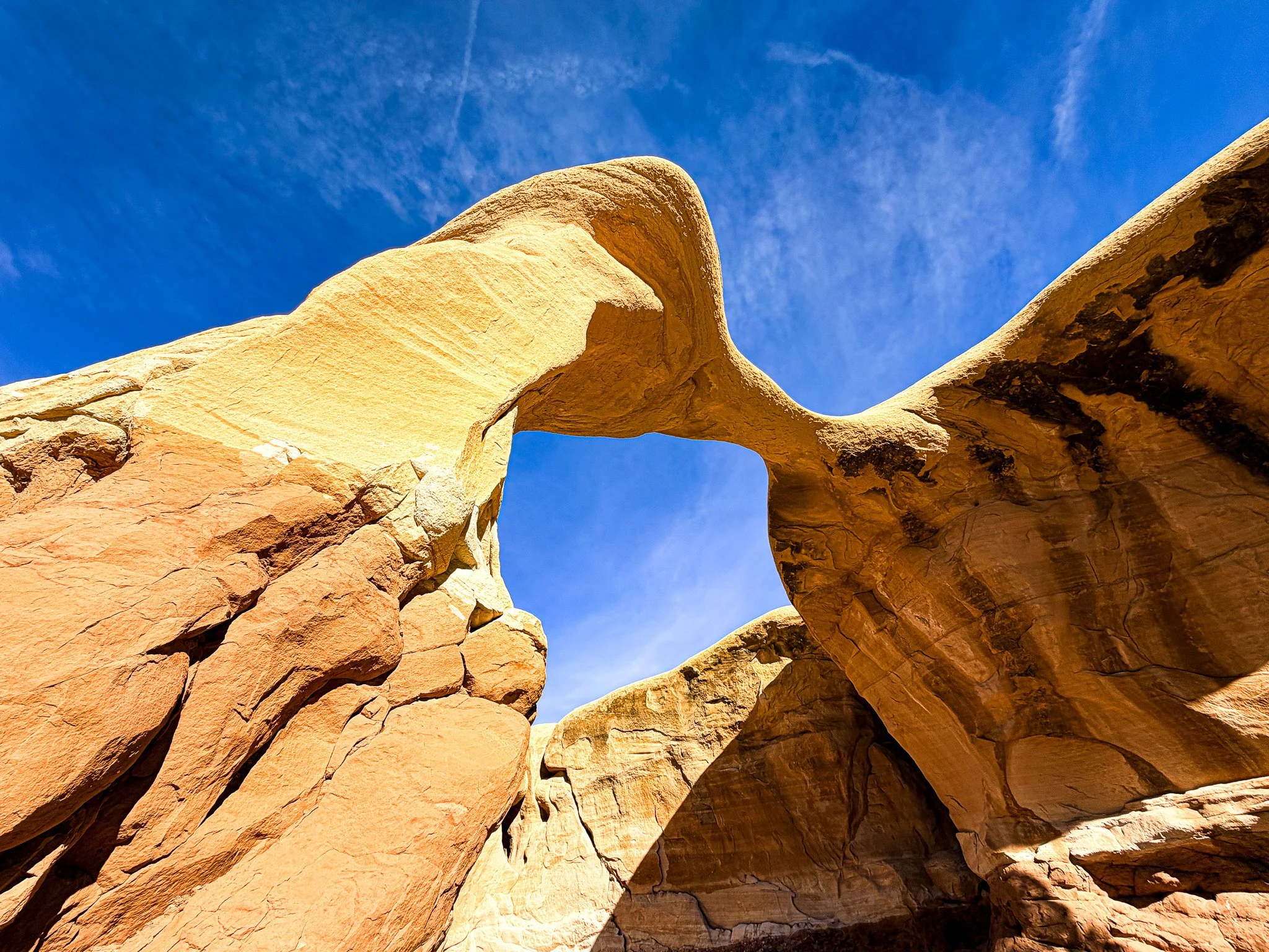 sandstone natural bridge formation Devils Garden Escalante Utah blue sky