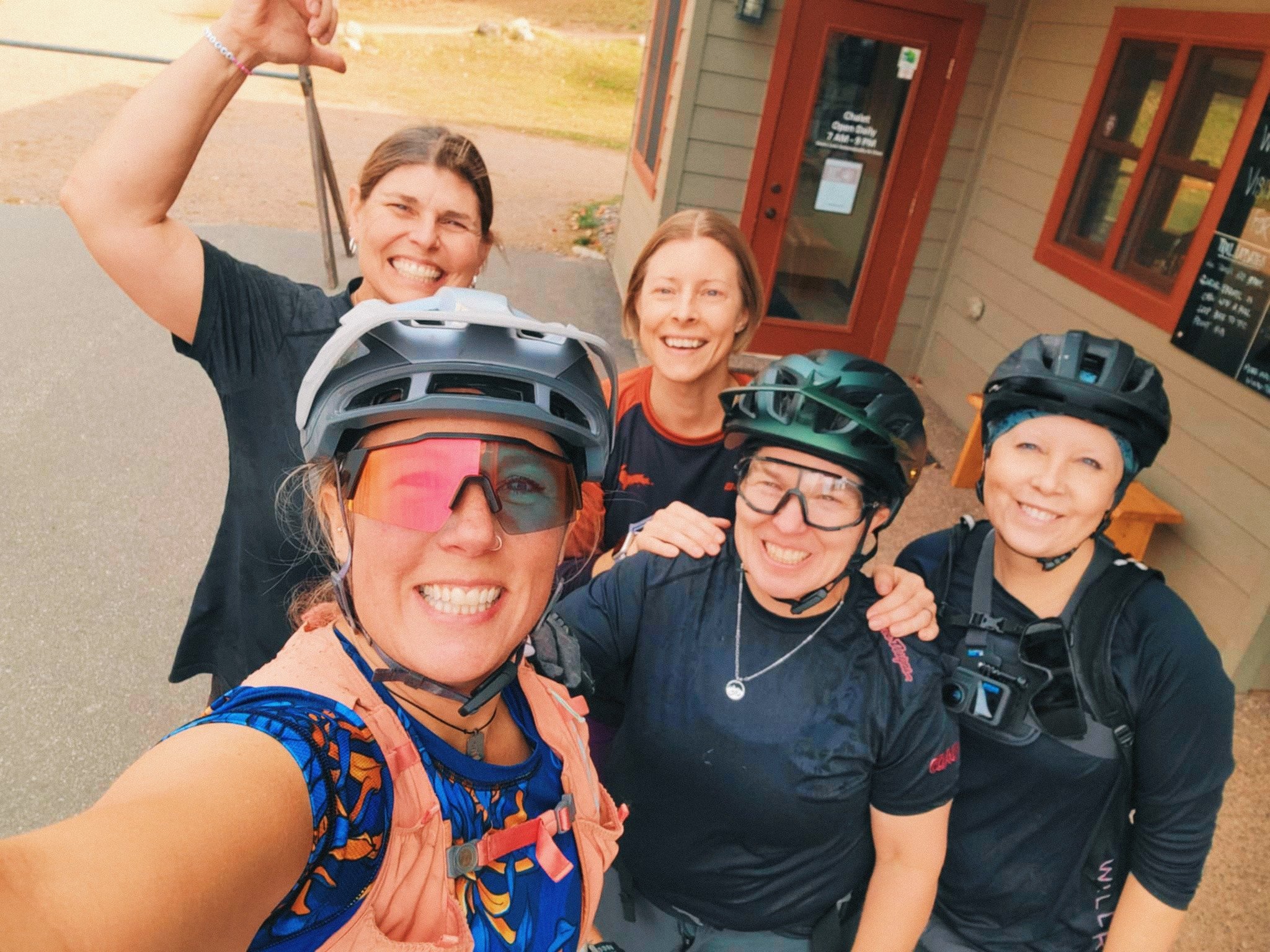 Group photo outside the Chalet at Winman Bike Park with Robin Grapa, Coach Brenda Zimmerman, Coach Karyn Iskra, Coach Kim Basala, and the author.