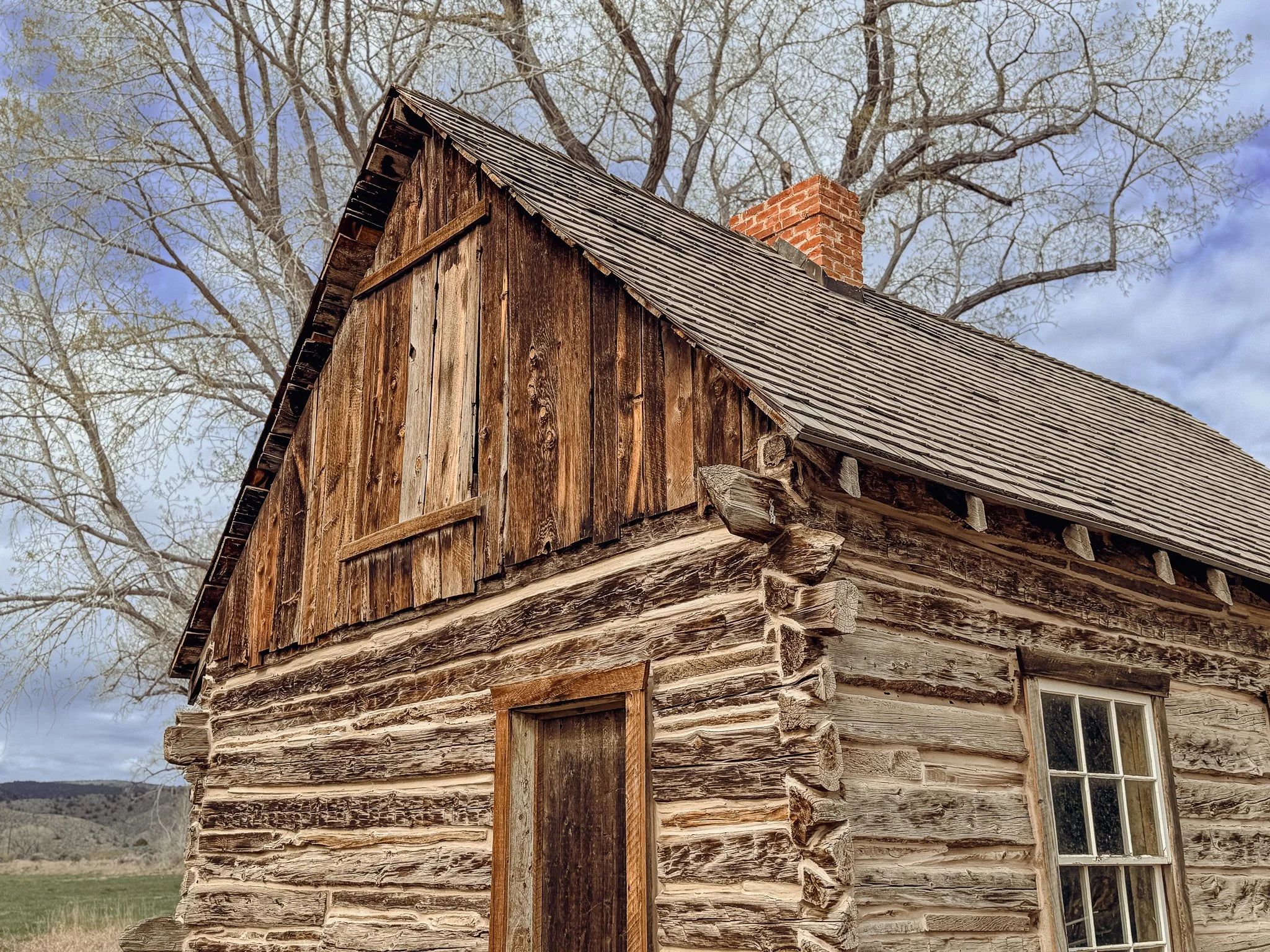 Close-up of the log construction and wooden roof of Butch Cassidy's boyhood home in Utah.