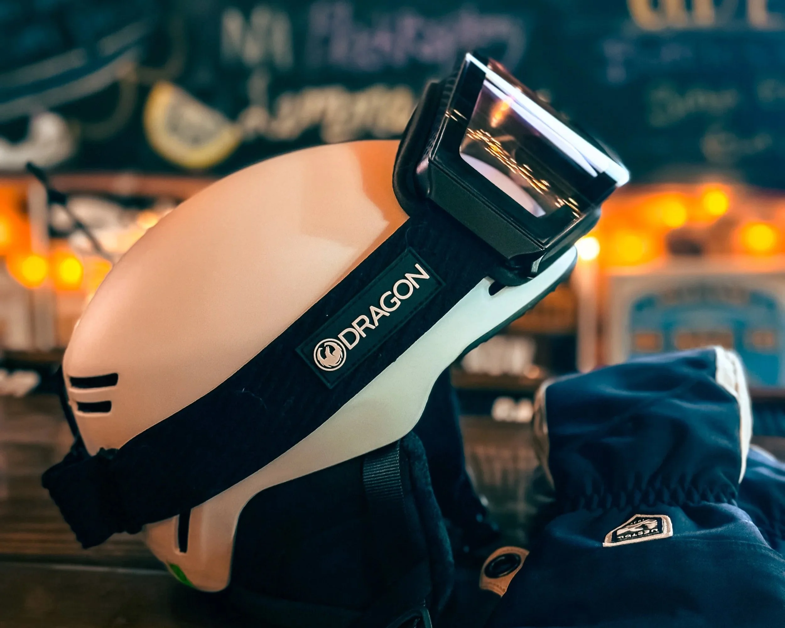 Close-up of Smith ski helmet with Dragon RVX MAG goggles and Hestra gloves on a bar at Powder Mountain.