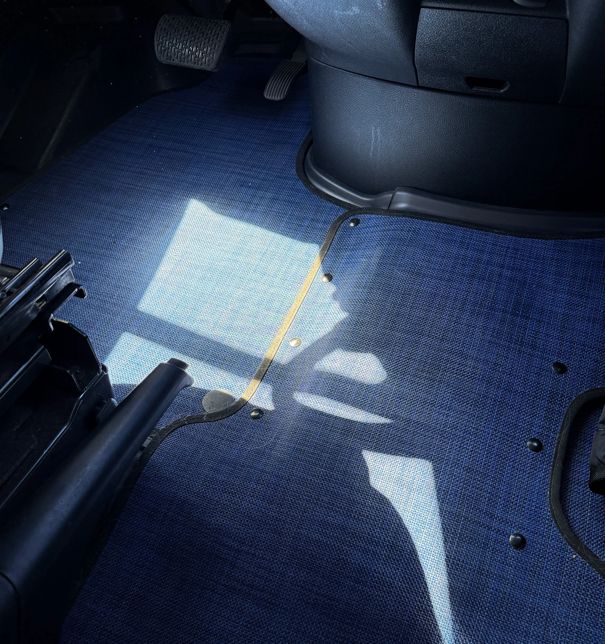 Inhabit Mats Indigo van flooring installed in driver area showing texture and fit