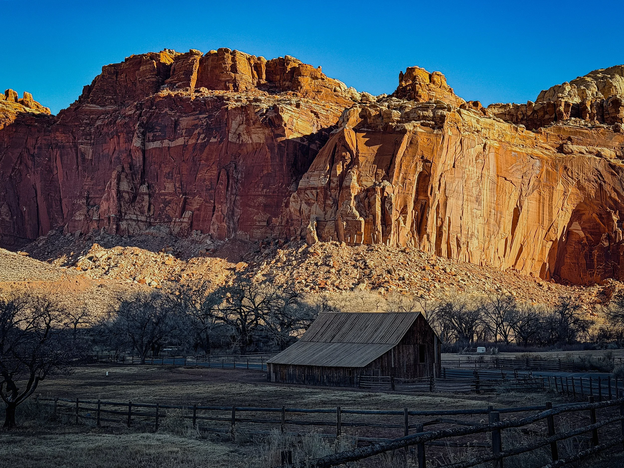 Historic barn in the Fruita district beneath red cliffs in Capitol Reef National Park Utah