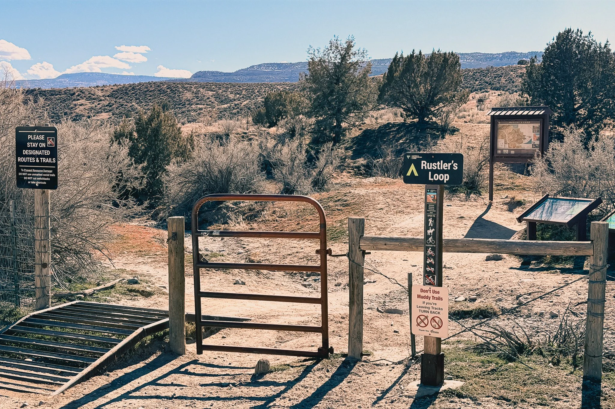 Rustler’s Loop trailhead entrance at Kokopelli Trails in Fruita Colorado with gate and desert mesa landscape