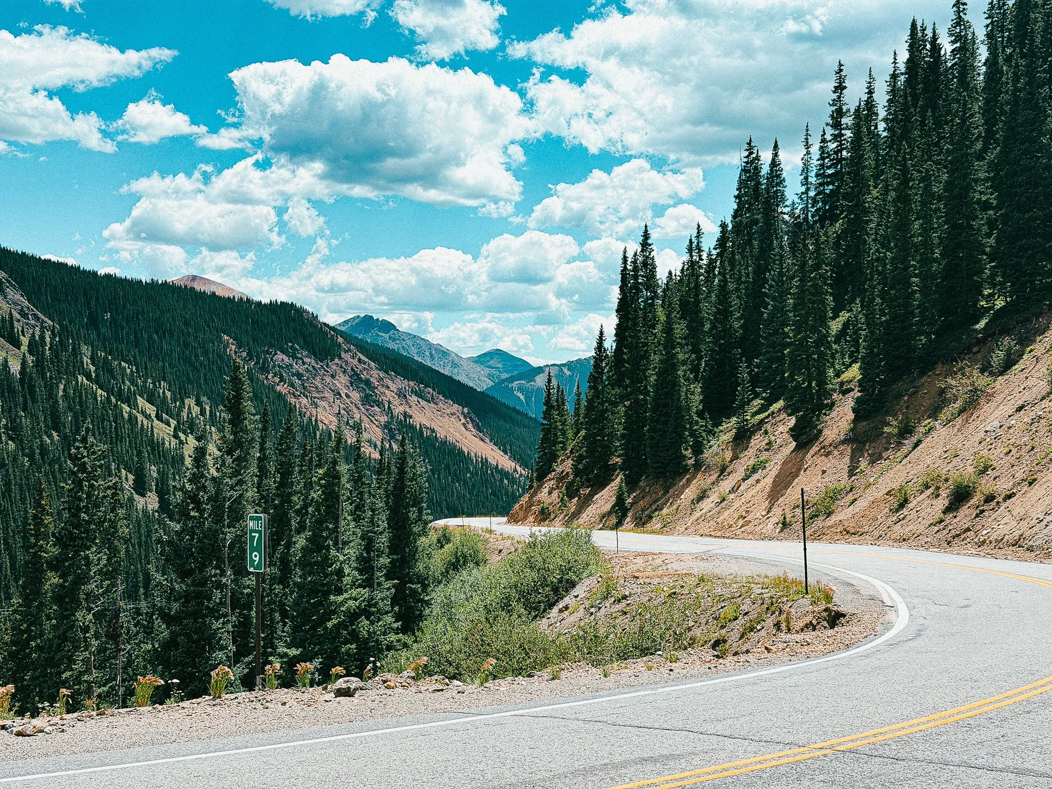 Million Dollar Highway curving through the forested San Juan Mountains in Colorado.