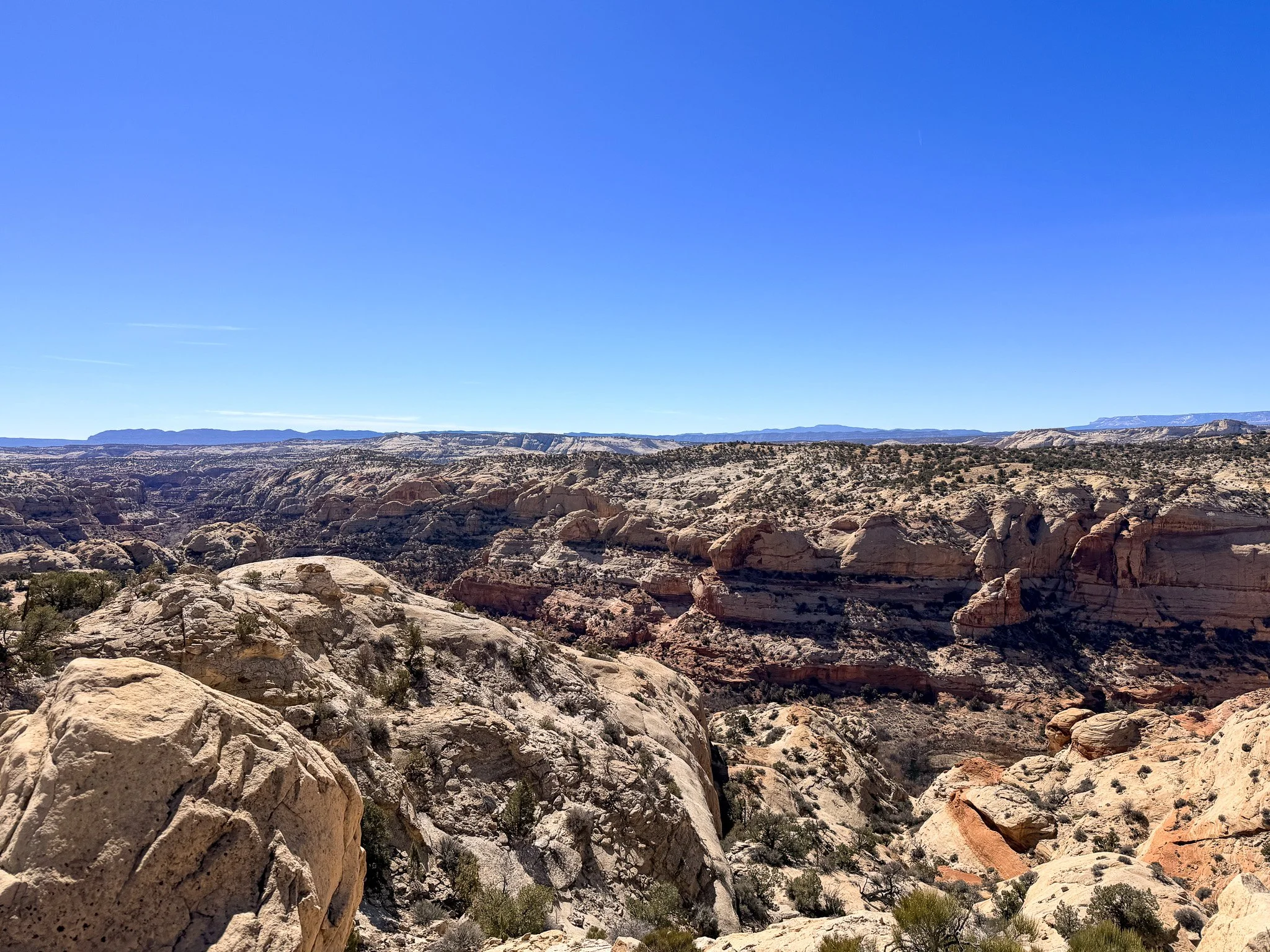 wide landscape view of Grand Staircase Escalante sandstone layers Utah desert