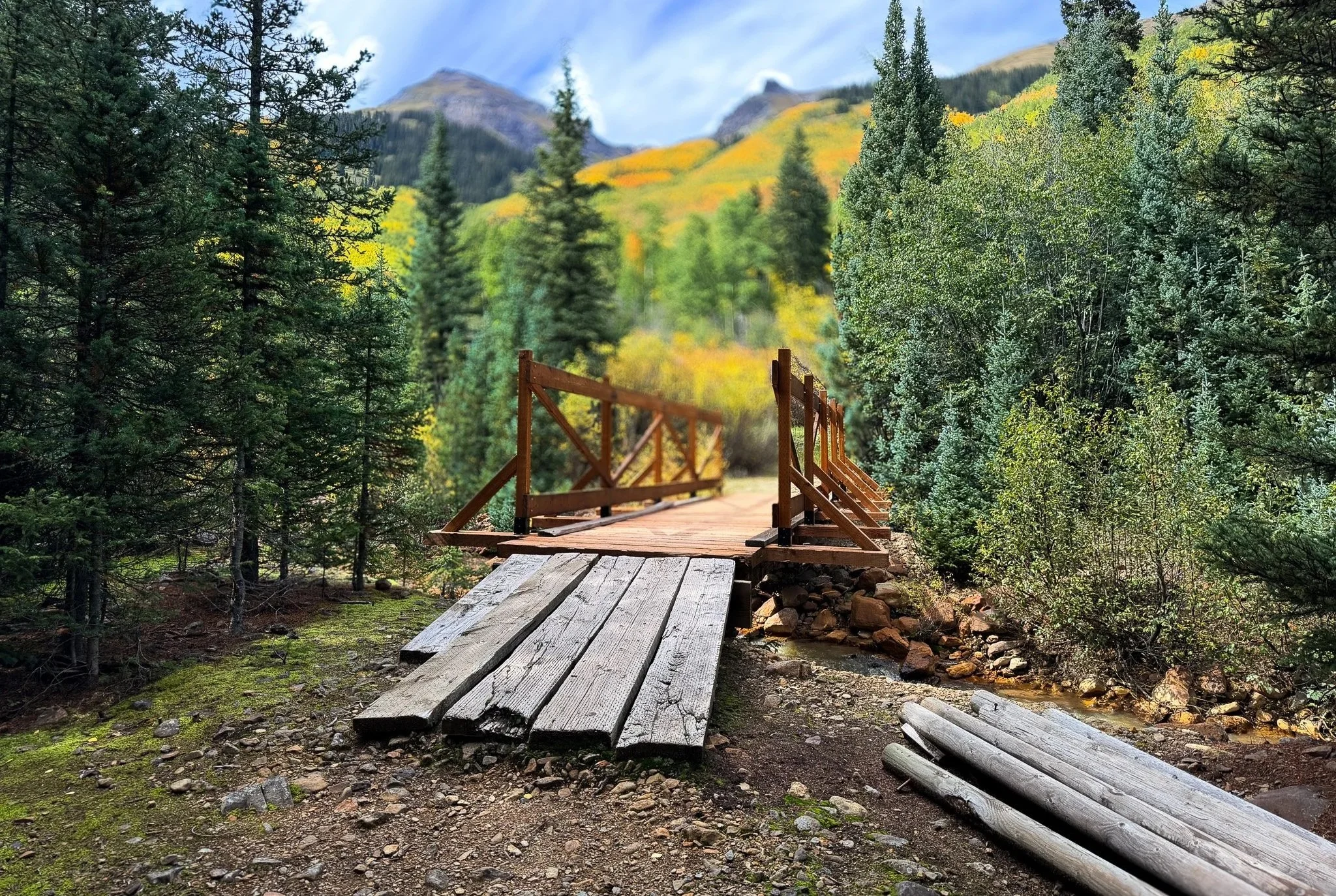 Wooden bridge crossing Red Mountain Creek on the trail to Colorado Boy Mine