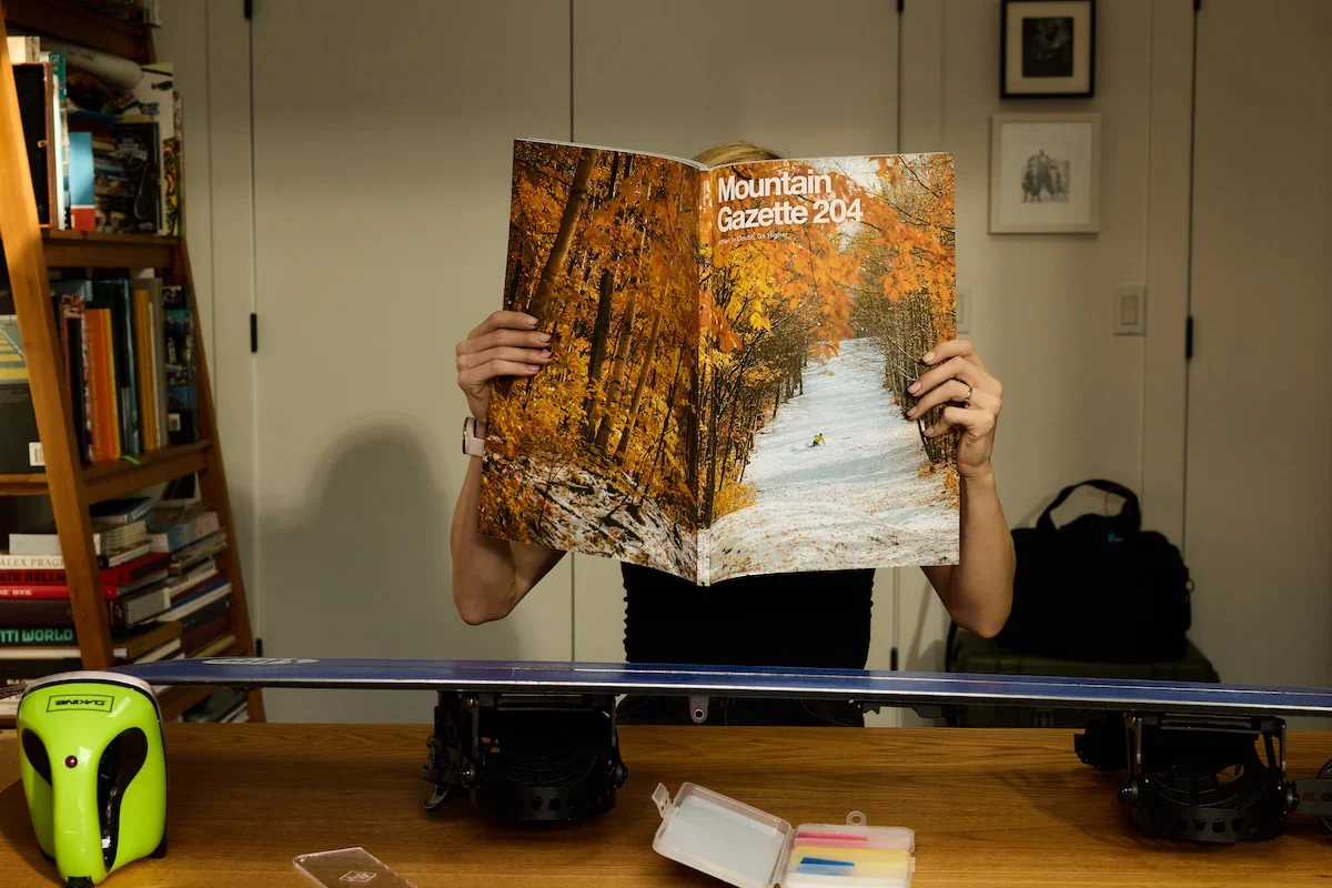 Person holding Mountain Gazette magazine showing oversized print format and photography
