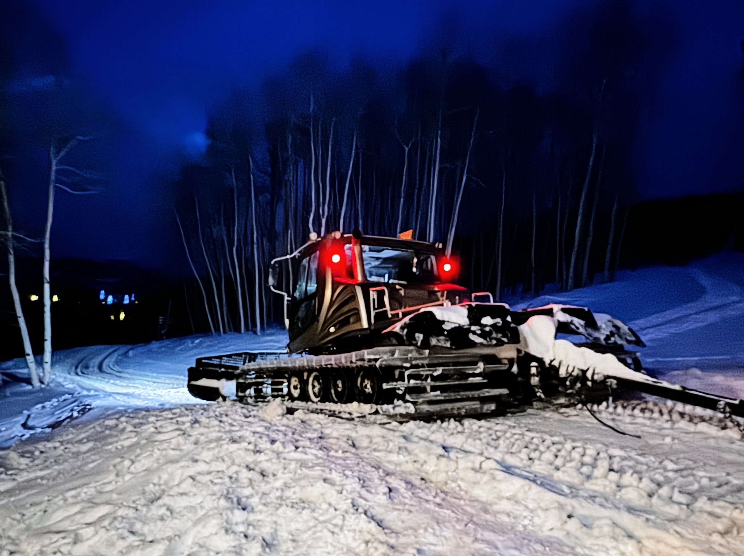 Snow Cat parked at the top of the mountain, ready to take guests back down after an evening dinner.