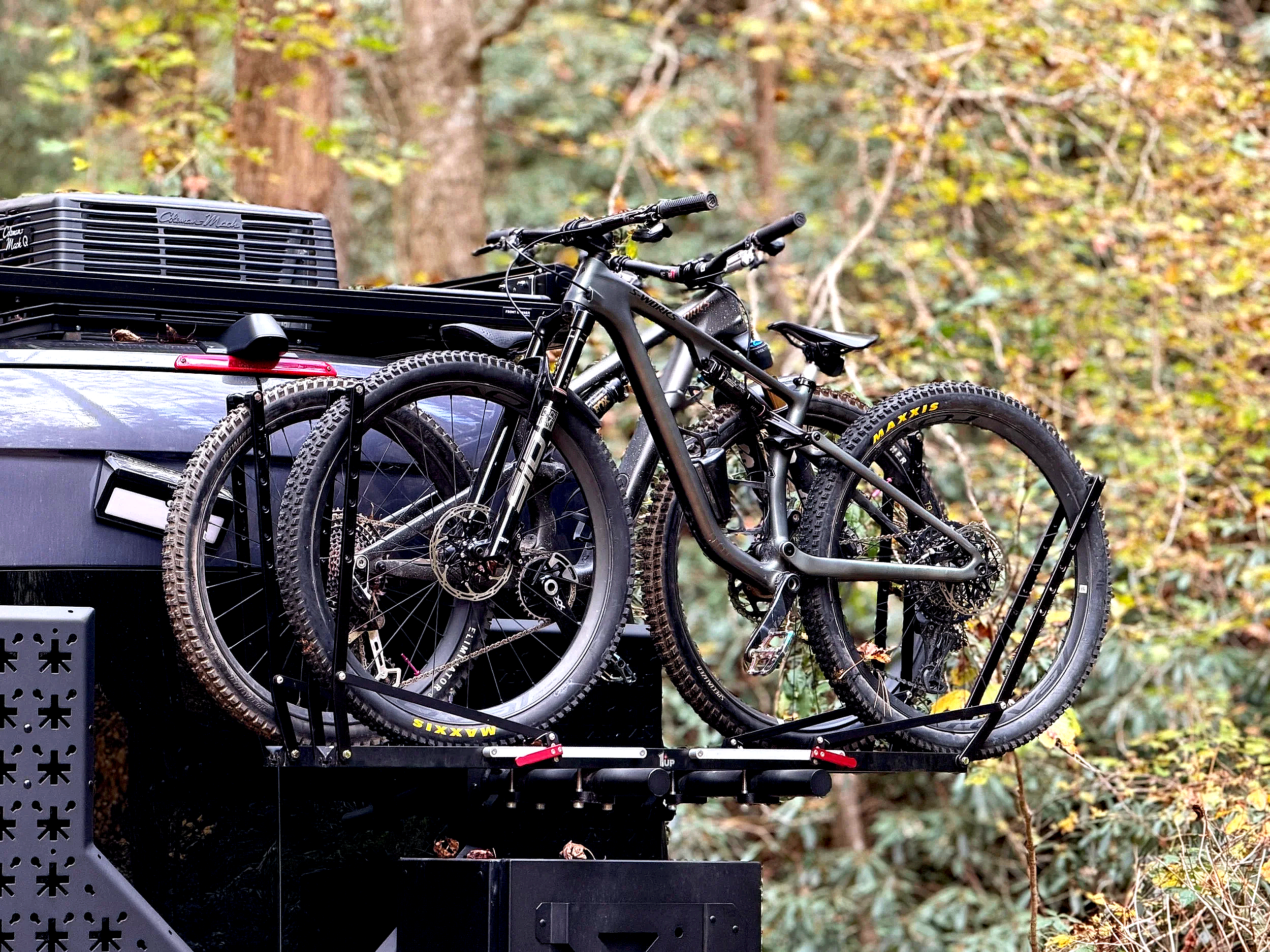 My trail bikes loaded on the rack at camp — ready for a day of riding.