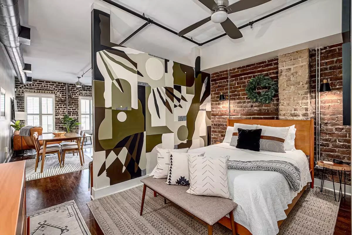 savannah vacation rental julu mural, brick walls, historic condo on broughton street,  top rated savannah airbnb and vacation rental