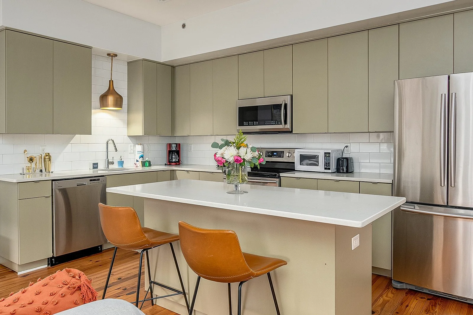 green vintage boho kitchen leather stools at island in historic condo savannah vacation rental broughton street