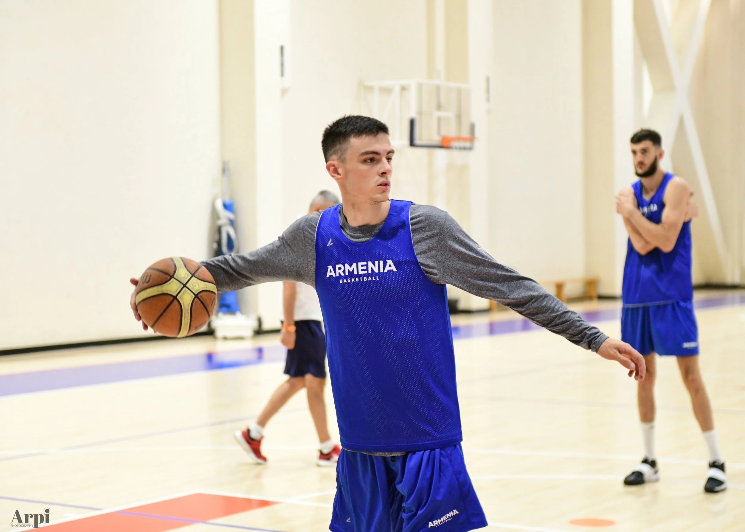 Basketball player in Armenia jersey during practice on indoor court