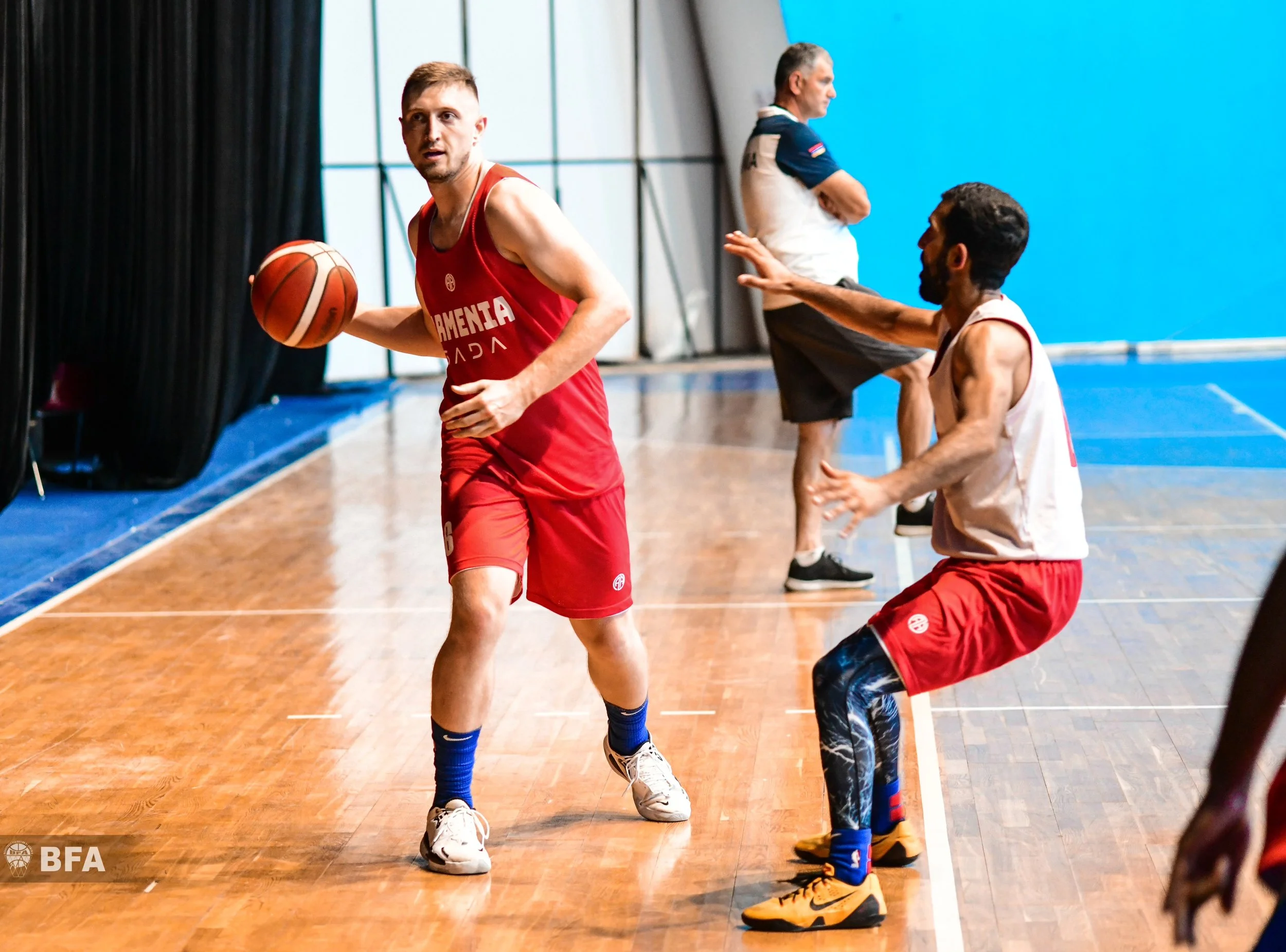 Basketball players on an indoor court during a game or practice.