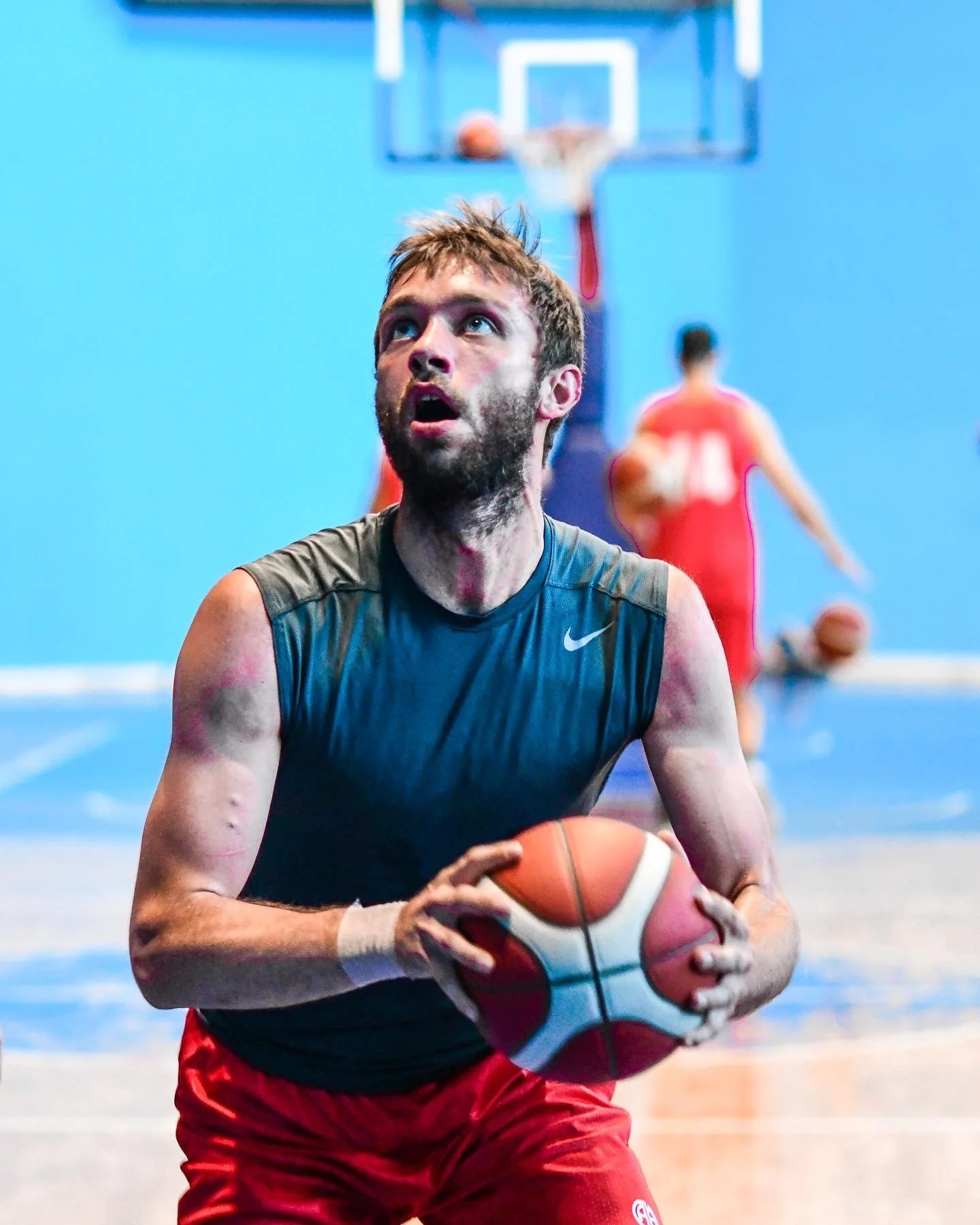 Basketball player preparing to shoot during practice on an indoor court