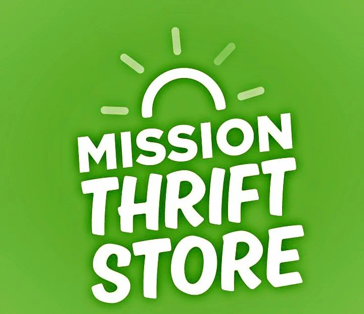 Green background with white text reading "Mission Thrift Store" and a stylized sun or light symbol above the text.